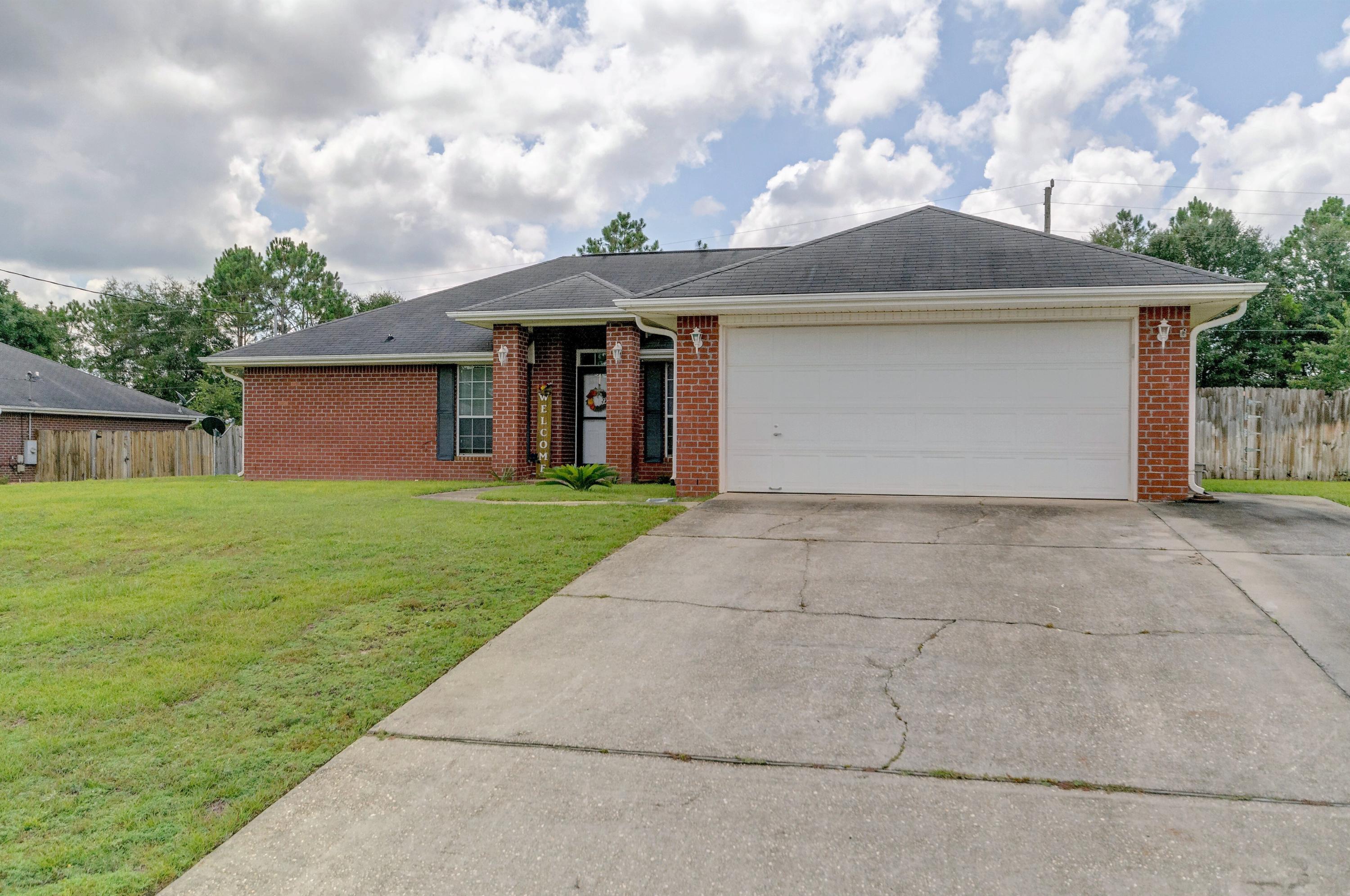 Located in south Crestview in Foxwood Estates.This 3 bedroom 2 bath home has upgraded designer tile in all wet areas and gorgeous wood flooring in the living room, dining room, hallways and the office. Wood burning corner fireplace in the living room, plant shelves for the decorator. Kitchen has breakfast bar, pantry, eat in area and stainless steel appliances. This is a split bedroom plan with a private master suite. The master bath has his and her vanities, garden tub/shower and his and her walk in closets. A screened in patio looking out to the large level back yard. The back yard has a huge fenced in back yard. The yard has an irrigation system. Home is located at the end of a cul-de-sac.