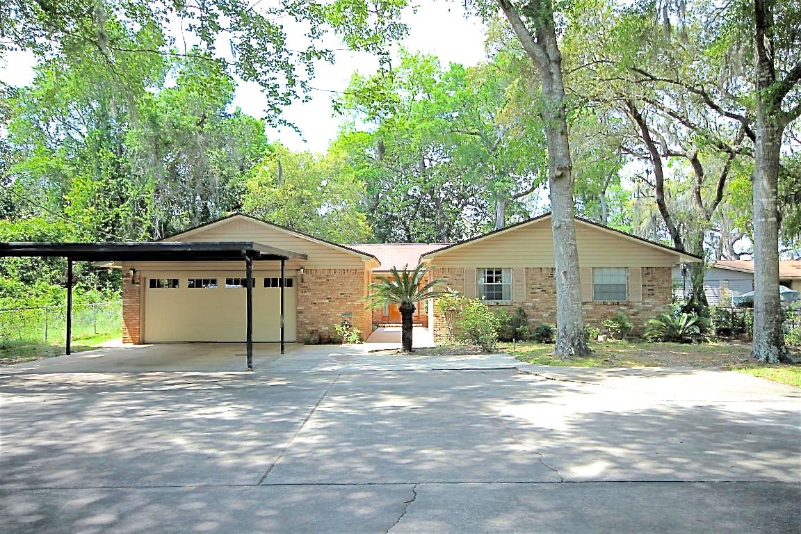 Enjoy spectacular views of Don's Bayou from your home and backyard and enjoy the lifestyle of living on the water, which includes boating, paddle boarding, fishing, jet skiing, and more! This 2001 sq ft, 4 bedroom/2 bath waterfront home sits on approximately .83 acres of land, has 70 feet of water frontage, a boat dock, covered slip, and lift! No flood insurance required due to elevation of the land and home! This gorgeous, deep lot is covered in mature vegetation and boast magnolias and palm trees! There is a 289 sq ft of open deck built around a large magnolia that overlooks this deep water slip! Sit and relax on this elevated deck and watch the dolphins play!