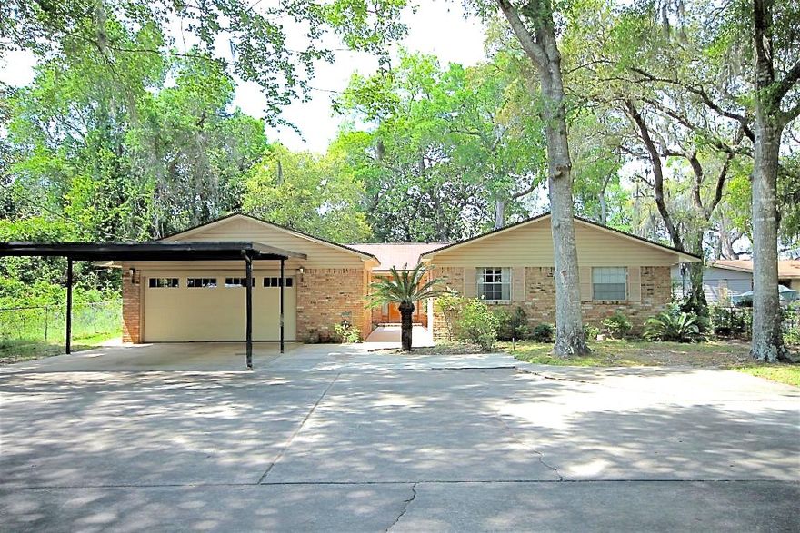 Enjoy spectacular views of Don's Bayou from your home and backyard and enjoy the lifestyle of living on the water, which includes boating, paddle boarding, fishing, jet skiing, and more! This 2001 sq ft, 4 bedroom/2 bath waterfront home sits on approximately .83 acres of land, has 70 feet of water frontage, a boat dock, covered slip, and lift! No flood insurance required due to elevation of the land and home! This gorgeous, deep lot is covered in mature vegetation and boast magnolias and palm trees! There is a 289 sq ft of open deck built around a large magnolia that overlooks this deep water slip! Sit and relax on this elevated deck and watch the dolphins play! The all-brick home is extremely well-maintained! Pride of ownership does show! There is a two car garage and an additional covered parking space for two additional vehicles. Plenty of room for parking additional boats, RVs, and trailers! The home has a kitchen that opens to the living room. The living room has a fireplace and sliding glass doors leading to the open patio, which overlooks the water. The home also features a second living room and more formal dining room space! The master bedroom is perfectly located to allow for views of the bayou! There are also an additional three bedrooms and one full bath! Renovate this home and maintain some of the original charm and beauty! This home is located near some of the best Schools in our area, the air force base, restaurants, shopping, and beaches! HVAC 2006 yr, Hotwater heater 2010 yr. Home has copper wiring. Buyer to verify all information and dimensions.