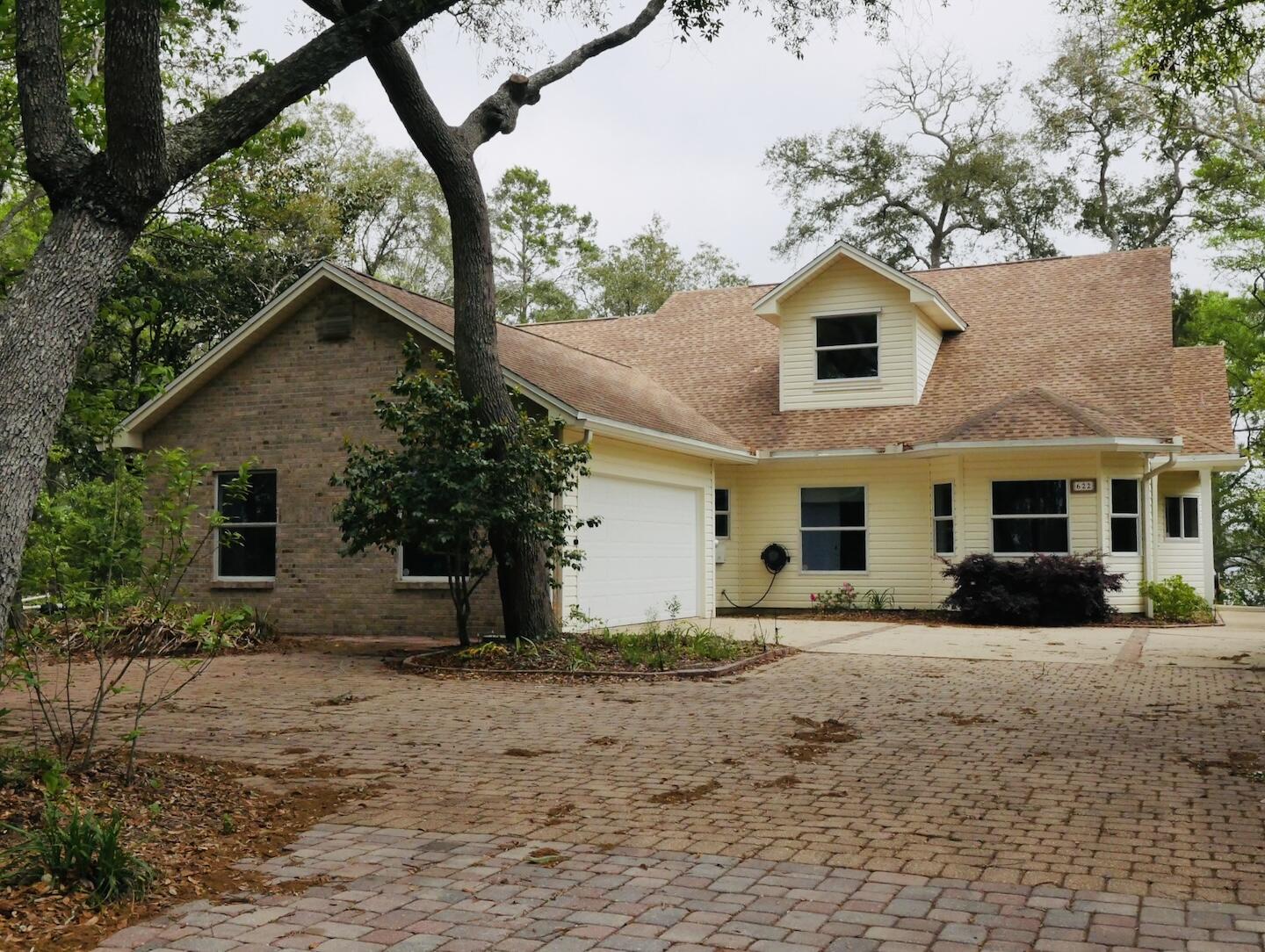 One owner, custom built waterfront home on picturesque Rocky Bayou in Niceville. This home is located on 'Sailboat Cove' offering deep, protected water and does not require any flood insurance due to the high elevation of the lot. The long paver drive through beautiful trees leads you to this home. Upon entering, you will find a formal dining room on the left and a roomy kitchen on the right. The kitchen is open to the breakfast area and family room with a wall of windows overlooking the bayou. There is a convenient office just off of the family room and also a large screened porch and deck along the back of the house.. The master bedroom suite, two additional bedrooms and a full bath are downstairs and upstairs is another bedroom, the 3rd full bath a bonus room and a large storage area.