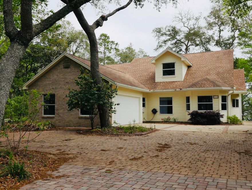 One owner, custom built waterfront home on picturesque Rocky Bayou in Niceville. This home is located on 'Sailboat Cove' offering deep, protected water and does not require any flood insurance due to the high elevation of the lot.  The long paver drive through beautiful trees leads you to this home. Upon entering, you will find a formal dining room on the left and a roomy kitchen on the right. The kitchen is open to the breakfast area and family room with a wall of windows overlooking the bayou. There is a convenient office just off of the family room and also a large screened porch and deck along the back of the house.. The master bedroom suite, two additional bedrooms and a full bath are downstairs and upstairs is another bedroom, the 3rd full bath a bonus room and a large storage area.
