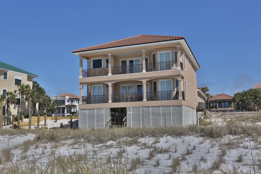 Over a $300,000 price drop! Seller wants this home to be the next beach-front home to sell. This spectacular Gulf-Front Luxury home is a one of a kind 5 bedroom custom property that has it all. A grand entry foyer with a powder room, extra-large Great Room with a gas fireplace, french doors, sitting area, and formal dining area with three sets of sliding doors leading to the grand outdoor balcony overlooking the white sandy beaches and emerald waters. There is a mini-master suite on the first floor with a granite vanity and separate tub/shower. Beautiful solid oak wood floors and crown molding throughout. Enjoy top of the line GE stainless steel kitchen appliances, granite counters, and beautiful views while you're cooking! The second floor has an additional 4 bedrooms including an