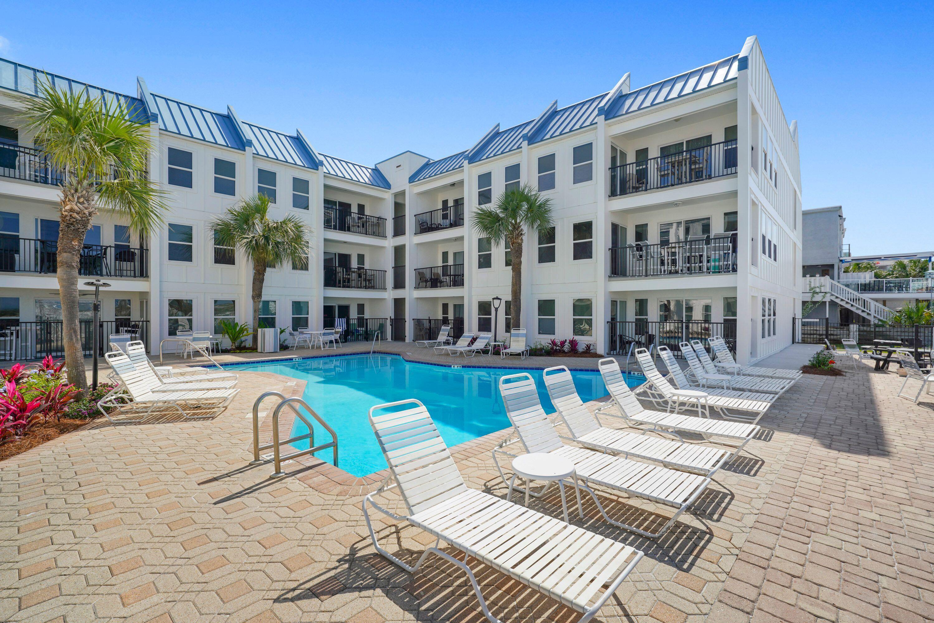 Your 'Piece of Paradise' awaits you on desirable Holiday Isle! This ground floor, end 2BR/2BTH unit features updated floors, newer appliances, newer HVAC, porcelain tiles in guest bath, quartz tile floor in master bath, laundry in unit. Catch a glimpse of the Gulf from your kitchen window or dip your toes in the Emerald waters! The beach access is just steps from your door and a short stroll out to the sugary white sand beaches! Poolside Villas is a gated complex with only 30 units giving it a secluded feel, yet convenient to Harborwalk Village, fine dining, fishing, breathtaking sunsets, all the very BEST of DESTIN! It offers a large pool, grilling area and ample parking. Unit #103 has been well loved and maintained as a primary home, is being sold unfurnished, ready to create your own coastal retreat! The building has recently undergone a beautiful $2M exterior renovation, making it sparkle like new and will make a perfect primary, vacation or investment home with projected rental income of $45K-$55K! Special assessment has been 'paid in full' and the building meets the state milestone inspections. A MUST SEE!