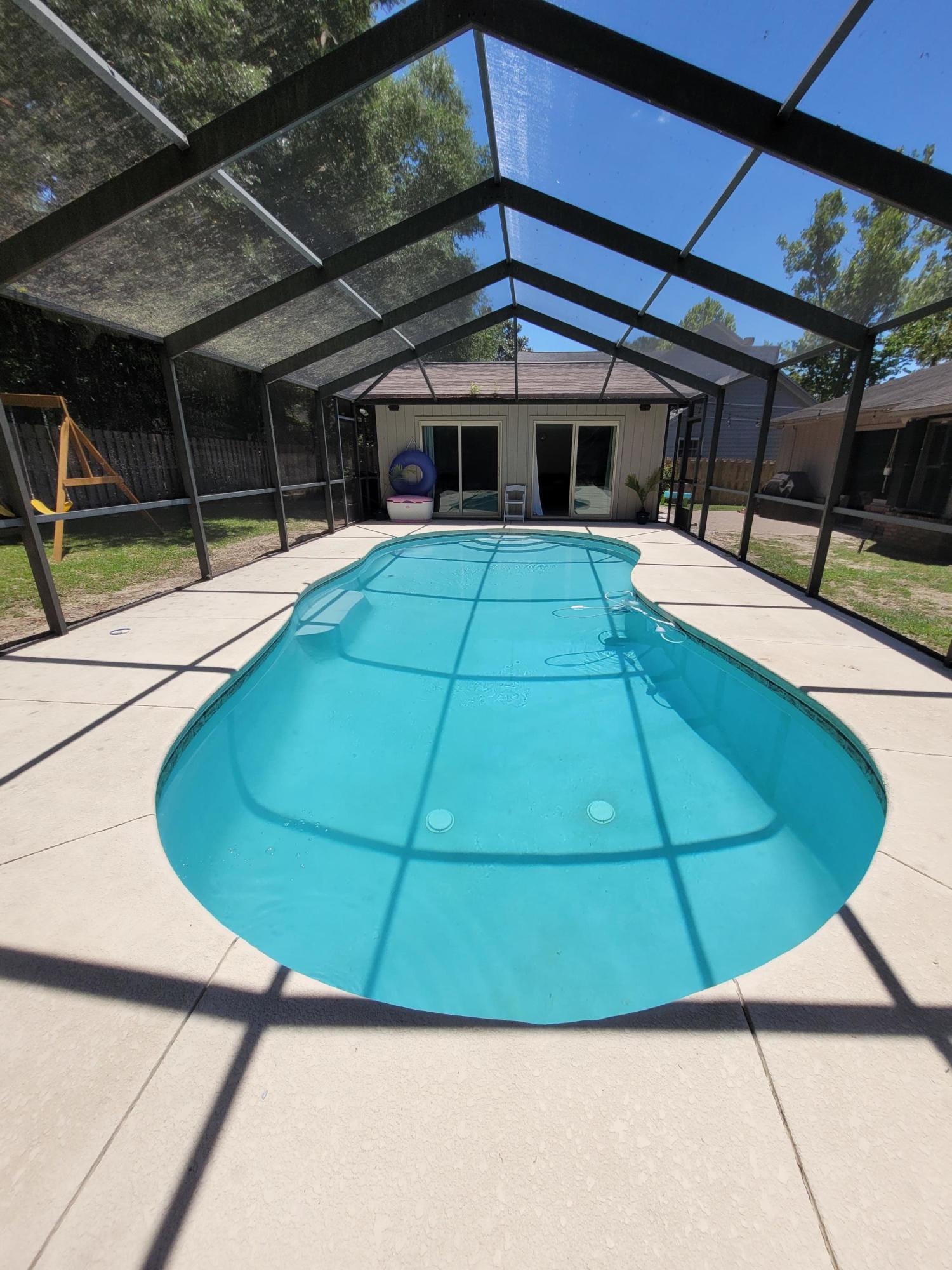 Located in Bluewater Bay, this three bedroom two bath home features a salt water in-ground pool with screened enclosure and a pool house. When you approach the front covered patio there is a quaint courtyard to your right. Enter into the spacious foyer and straight ahead is the dining/living room with high vaulted ceilings and a skylight complemented by a brick fireplace and new tile floors throughout the home. Fresh paint and new interior doors. Kitchen cabinets are white, enhanced by granite counter tops. There is a kitchen nook with a window overlooking the lovely fenced-in backyard. The split bedroom layout is a favorite and one of the additional bedrooms can be used as an office with French doors opening to the foyer. The master bedroom is set back off the kitchen and features the
same new floors. The master bath has a double vanity and large corner shower. There is an exterior door leading to the backyard for a quick dip into the pool.
Newly replaced HVAC and Hot water tank plus renovation throughout this home. Pool has fresh gunite skim coat.