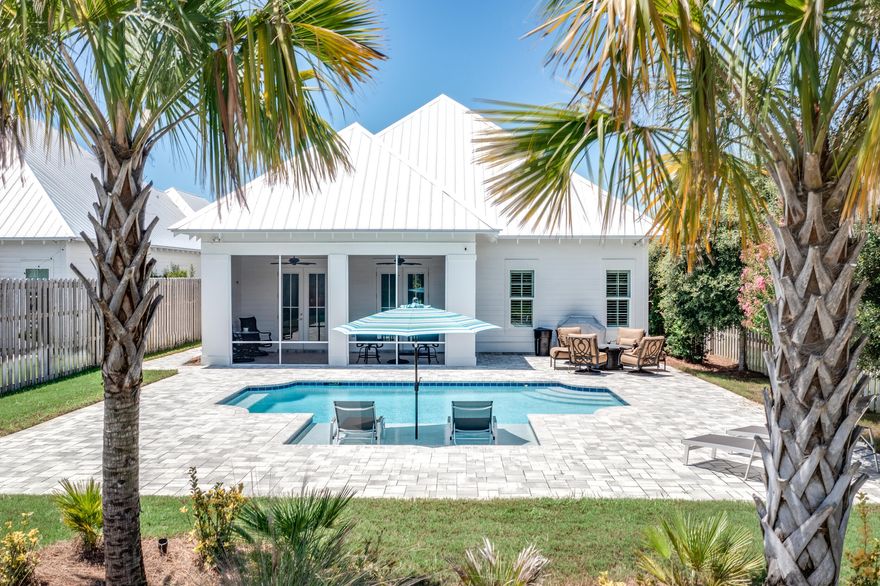 Priced to sell - $100/sqft less than the last sale on Deno Drive! Great location & non rental community located less than 1/4 mile from the beach and Gulf Place. This corner lot home with pool has been meticulously maintained and full of beautiful upgrades. Relax on the screened porch & take in the peaceful backyard and private pool. This homesite is perfectly situated backing up to a wooded preserve for the utmost privacy. This floor plan is mostly first floor living with 3 bedrooms/ 3 baths all downstairs. Kitchen was built for a chef with square island offering tons of storage, farm house sink, built in oven & microwave and induction cook top.