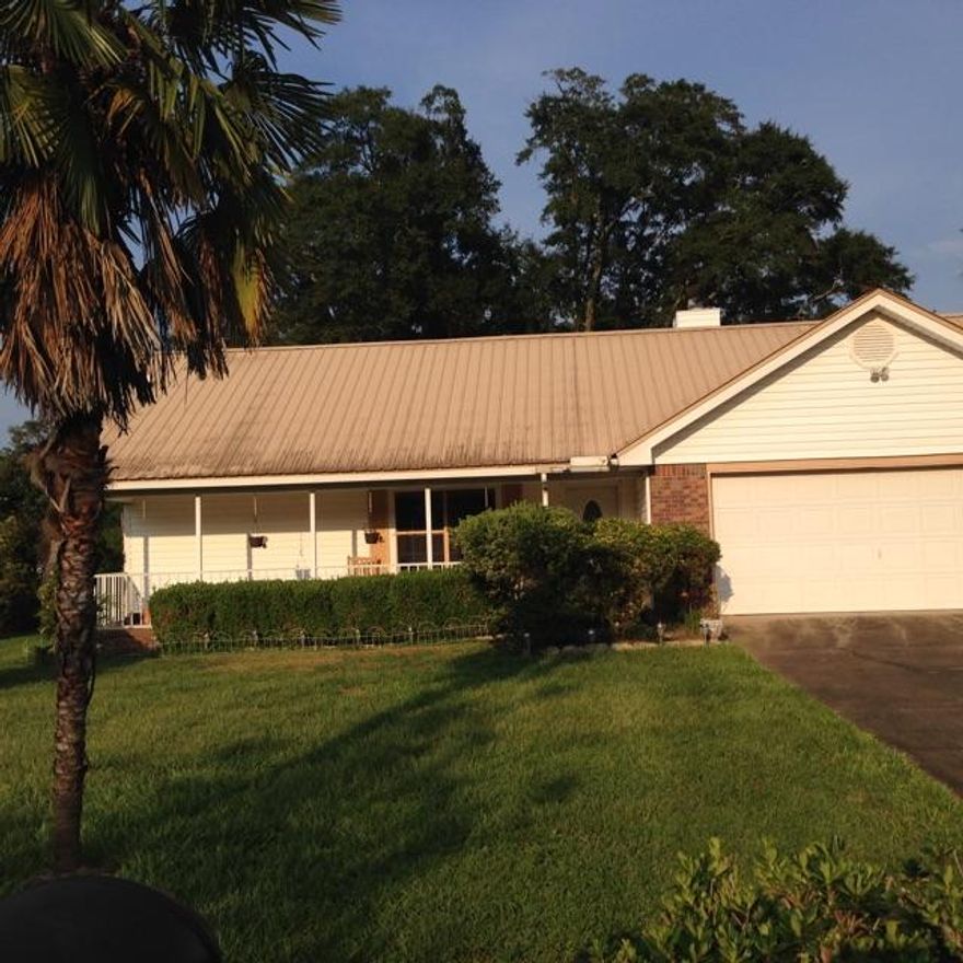 Well maintained home with a metal roof. Private well (80 feet) for thesprinkler system. Chained link back yard with a separate chain link dog pen.Cathedral ceilings in living room and master bedroom.Marble floors in kitchen,hall and front porch. Enjoy the screened sun porch with outdoor carpet and also the covered deck. New cooling and heating system 2 years ago. Master bath has a large walk-in closet.