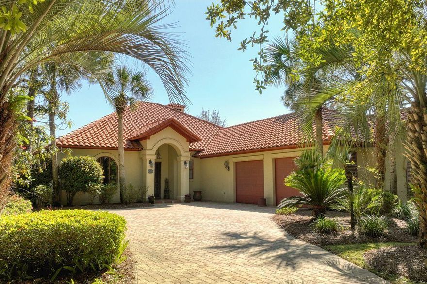 This single story lakefront home is tucked into the exclusive non rental neighborhood of DelMar at Sandestin with views of the lake and the fourth hole of the Baytowne golf course. Enter the custom built home through antique carved wooden double doors to a dedicated foyer. A formal dining room features a large arched window with decorative iron grill and coffered ceilings.  The gourmet  kitchen includes a gas cooktop, butcher block island with prep sink, wine refrigerator, breakfast bar, a desk area and so much more- any chef will appreciate the details. A wood-burning fireplace flanked with built-in cabinets centers the living area. Sliding glass doors provide optimal light to show off the spectacular views and provide access to the covered lanai with more than 500 square feet of outdoor