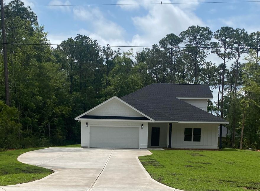 Nestled in the desirable community Lagrange Shores, this home offers 4 bedrooms, 3 bathrooms and 2453 living space. Featuring a luxurious kitchen equipped with stainless steel Samsung appliances, custom cabinetry, designer tile backsplash, expansive center island, and granite countertops; and a master ensuite with a generous free-standing soaking tub, and complete with a glass-enclosed walk-in shower, fit with designer tiling. A modern farmhouse design concept, this home will feature board & batten siding, black windows, and matte black finishes.In a prime location, just 2 miles from Freeport Regional Sports Complex. Located within 5 miles of all Freeport Public Schools, and 17 miles to the sandy beaches of 30A.