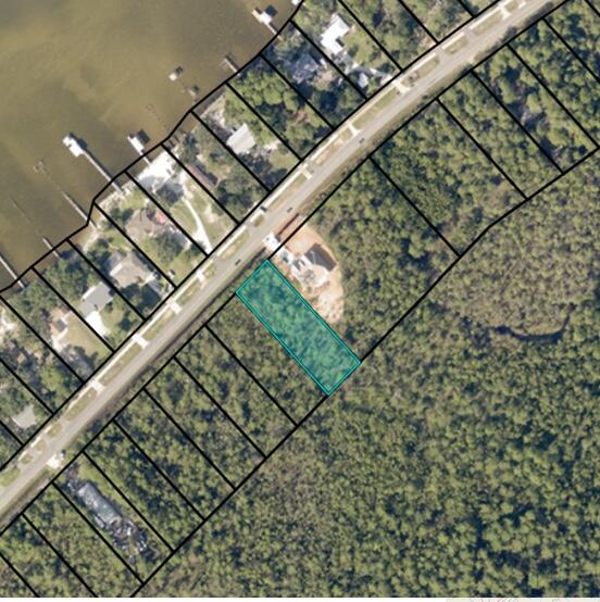 Wake Up to Water Views: Build Your Dream on the Edge of Paradise! Imagine warm breezes whisper through as you sip coffee on your balcony, gazing across the shimmering expanse of East Bay. This incredible lot in the Lagniappe Beach area, nestled on the border of Gulf Breeze and Navarre is minutes from Navarre Beach: Sink your toes into sugar-white sand on the Gulf of Mexico, just a short drive away. Build Your Vision: No HOA restrictions so design your dream home as you please. Zoned Residential: Ideal for families, retirees, or anyone seeking a large 100x300 foot water view lot. Utilities at your fingertips: Water, electric, and cable connections are readily available. This is more than just a lot; it's an opportunity to live the life you have always dreamed of.