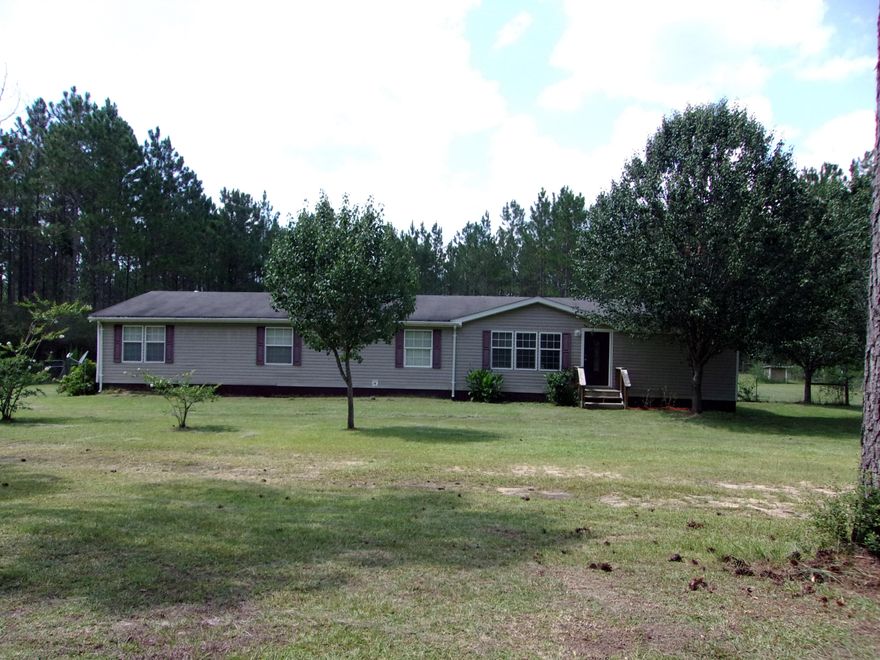 Large and well maintained manufactured home on 10 acres.  Home features 4 bedrooms and 3 full baths with storage around every corner.  Large master suite features huge walk in closet with built in cabinets the flows in to master bathroom with tub, shower and double vanity. Kitchen is massive with an island and cabinets that extend one entire wall.  Home also features two living spaces.  From the family room you enter the three additional bedrooms.  Two of the bedrooms share a Jack/Jill bathroom while other bedroom would be perfect for office space in additional bedroom is not needed.  The large utility room has additional storage and has a door leading to the side porch.   The covered back porch is perfect for family gatherings or just sitting and enjoying the country.