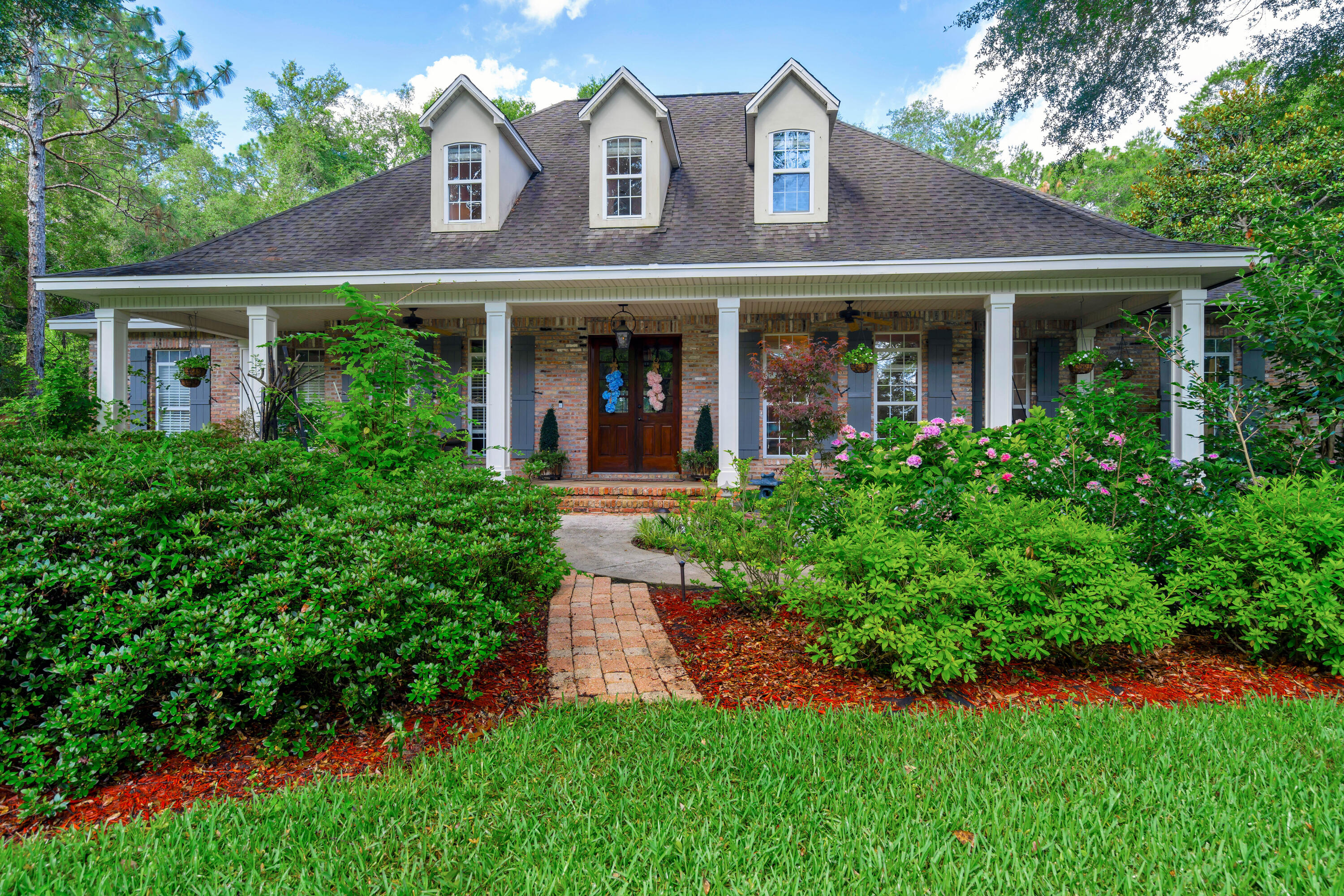 Beautiful custom built home in the sought after Swift Creek community. Gorgeous screened in oasis including a salt water pool that backs up to a wooded area that will never be built on. Natural gas appliances and fire place in the family room.This home boasts beautiful French Acadian style architecture inspired by A. Hays Town.Acid Etched concrete flooring throughout main floor of the home.Master Bathroom includes marble counter tops and over sized walk in closet with build in shelving, soft close drawers and lighting under shelves.Call your favorite realtor today and come take a look.