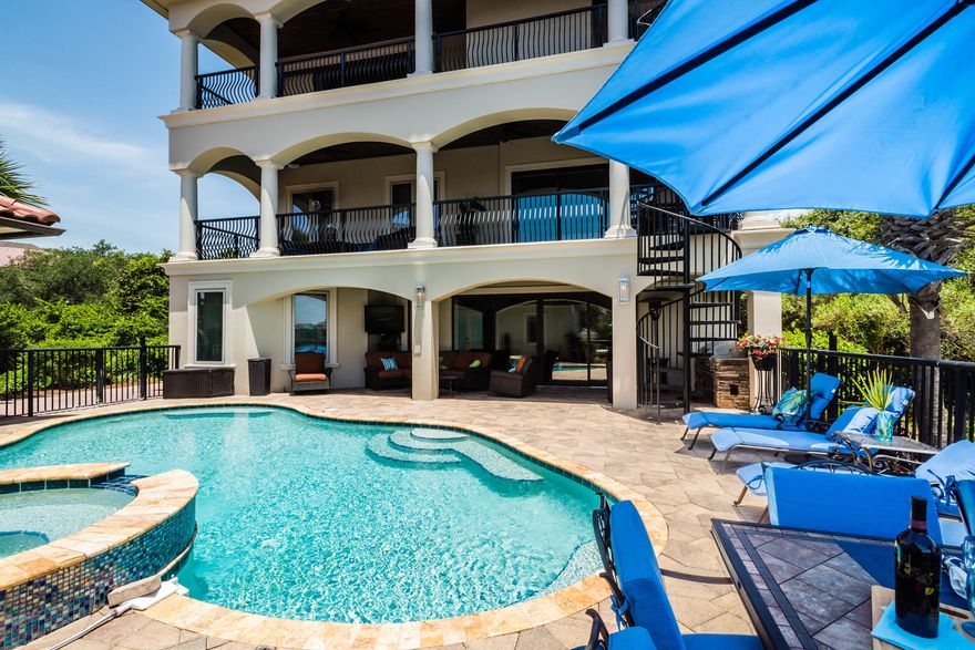 Find endless water views at this impeccable lake front residence with private pool and elevator in the gated Destiny West community with views of the Gulf of Mexico from the third level. An elegant Mediterranean style defines the interior spaces that have been thoughtfully designed to comfortably host a crowd with 6 bedrooms, 5.5 bathrooms and nearly 5,700 square feet. A grand entrance complete with mahogany doors and spiral staircase welcomes you into a first-floor family/media room with ample room to entertain. Two guest bedrooms are also on the first level along access to both a breathtaking outdoor living area with private heated pool and spa and a detached carriage home with one bedroom. Gorgeous open concept living and dining spaces are highlighted by an ornate gas fireplace, arched