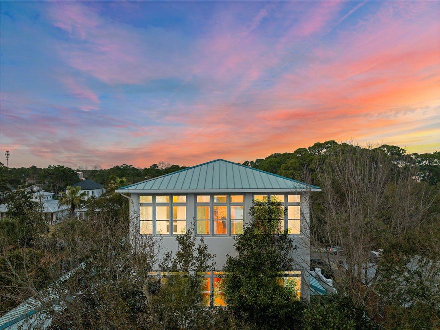 For sale at only $430.00 per square foot, and priced significantly below other 30A area homes is a gorgeous custom-built white stucco home situated along South Walton's iconic 30A in the non-HOA Gulfview Heights community. In addition, the sellers will issue buyers at closing a cashier's check or credit for $62,000 to cover the cost of a state-of-the-art two-person, cube-style glass pneumatic elevator (weight capacity 550-650 pounds) to be installed in the winding staircase. Installation time is 3 to 4 days after delivery.The home sits on a heavily landscaped .223-acre lot, perched 38+ feet above sea level (no flood insurance required), and is just a seven-minute stroll to the county-deeded beach access and 900 feet from the 30-mile paved bike trail that runs parallel to 30A. Conveniently located to dining, shopping, and entertainment venues.

Architecturally unique, the home features a reverse floor plan, perfect for smaller lots in beach communities. The third floor spans 2,100 sq. ft., maximizing space and offering a distinct living experience. With 12-foot ceilings, the living area feels massive, open, and airy while remaining private at the treetop level. The 8- and 10-foot windows and 10-foot double French doors (no window treatments needed), combined with the three-sided glass sun porch, provide abundant natural light and unobstructed views of unparalleled sunrises and sunsets. Luxury finishes include floor-to-ceiling solid cherry cabinetry in the chef's double kitchen and butler's pantry, plus a stylish half bath with a Kohler octagonal sink.

Complementing the third floor, the ground-level living space features a kitchenette and bathroom, opening to lush gardens and a patio enclosed by an 8-foot concrete wall with room for a pool.

The second-floor bedrooms are tucked away from noise and social areas, yet filled with natural light through multiple tall windows. The master suite, located in the south wing, offers peace and serenity with views of the gardens from its private enclosed porch.

This one-owner home has been meticulously maintained with no expense spared. Flooring includes solid hardwood, marble, and porcelain with knife-edge grout for a seamless finish. Additional features include granite countertops, solid maple and cherry cabinetry, forged hardware, 8-foot solid wood interior doors, Andersen impact-rated wood-wrapped windows, 8-foot double French doors with triple-locking systems, 10- and 12-foot ceilings, double and triple crown molding, 6- and 8-inch baseboards, and an open winding staircaseall exuding luxury and elegance. Ceramic and art glass exterior lighting and staircase sconces add a modern, art deco flair. The home is wired for surround sound and a generator.

The 9-foot garage doors accommodate large SUVs, while the porte coch??re (65' x 15' x 16' high) is equipped with water, sewer, 50 amp, 30 amp, multiple 15/20 amp outlets, recessed lighting, and Miami-Dade rated windows. This space can be converted into a carriage house or host a swim spa and sauna. The south-facing stacked porches, enclosed in 2018, added 960 sq. ft. of heated/cooled space with porcelain floors and wood-planked ceilings. A 60 sq. ft. pet/craft room was also added, featuring an Andersen impact awning window and two French doors, one leading to the garage and the other to an enclosed porch with an outdoor shower. In total, the home offers over 5,000 sq. ft. of heated/cooled living space and 7,037 sq. ft. under roof.

The home has four independently zoned HVAC systems (Trane, 2020), including one dedicated to the three-car garage, workshop, and pet/craft room. Enclosed porches are heated/cooled with Lennox mini-splits. Additional features include 12 new ceiling fans, spray-foam insulation in attic and walls, concrete-filled block construction, and a tree canopy on the south side that helps maintain an average electric bill of $200 or less per month.

This home is extremely stormworthy with superior fire protection. The first 10 feet of the home and the 16-foot-high porte coch??re walls are steel-reinforced concrete, as is the 8-foot wall surrounding the property. Steel rods extend through the exterior walls to the raised-seam metal roof. The second- and third-floor interior walls are plywood-reinforced, creating shear walls to prevent racking during storms. All plasterboard is ]-inch fire-rated X-board.

This majestic home has never been rented and is absolutely like newmove-in ready. Schedule your exclusive private showing today.