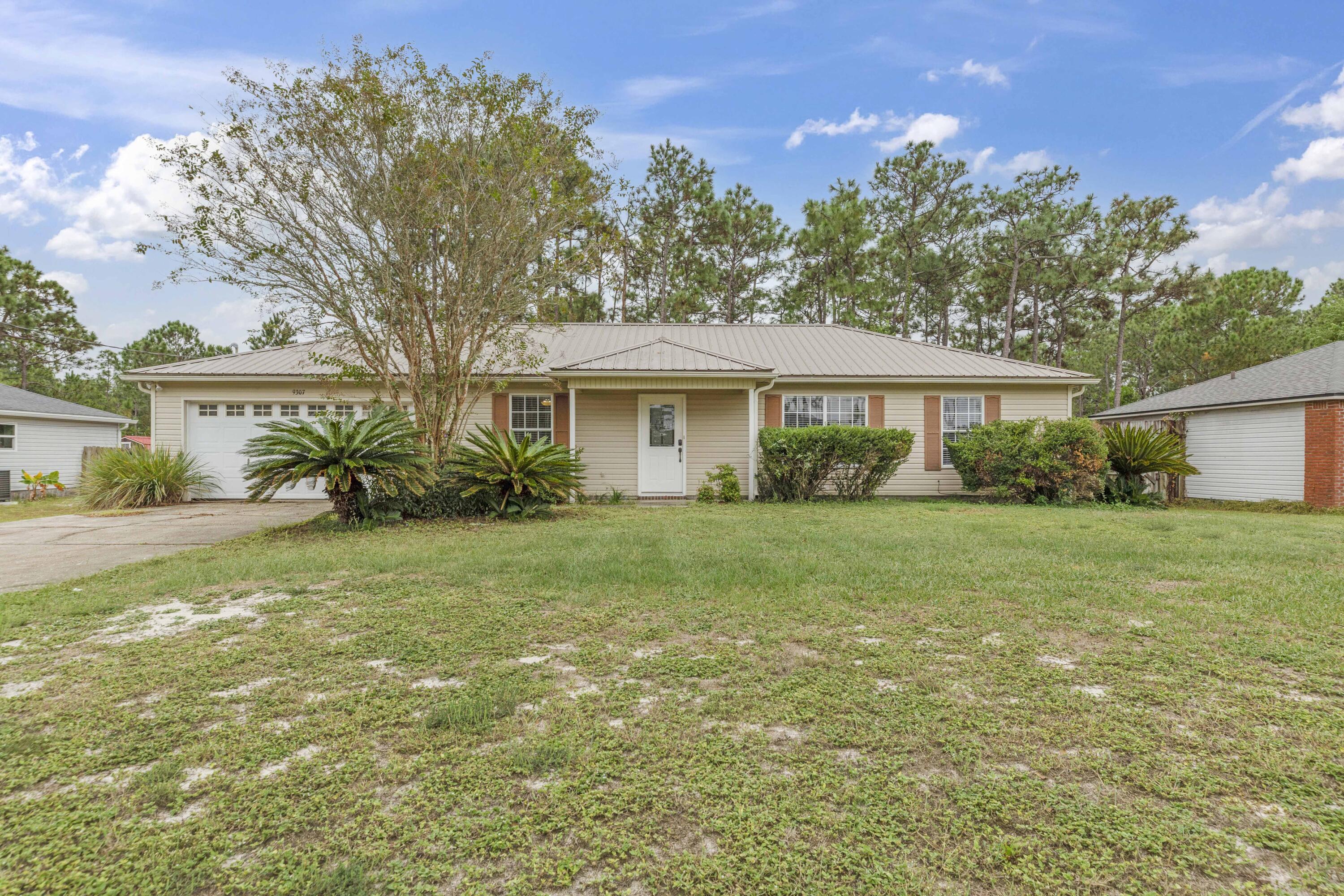 This single-family home is situated on .77 acres. Gives the feel of privacy but located within minutes of groceries, dining, shopping and more! Plenty of parking for RV, boat, or 6 vehicles. The exterior of home has a metal roof, large open back deck, partially fenced yard, and wooded back yard with no neighbors behind you. Inside the home you have no carpet but title flooring throughout. Split floor plan with the master bedroom to the left of the home and 2 additional bedroom to the right. The living area has vaulted ceilings and is open to the dining room. The kitchen has been updated with stainless steel appliances and granite surfaces. Well maintained and clean home. Seller will contribute towards Buyers closing costs.