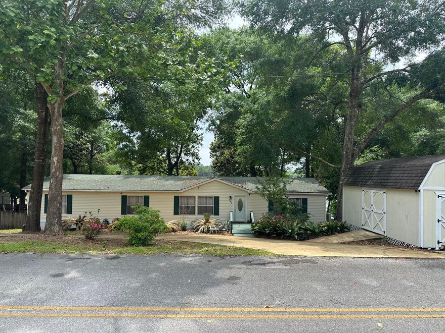 AWSOME PRICE IMPROVEMENT... LIVE YOUR BEST LIFE IN THIS BEAUTIFUL LAKERONT HOME!!This beautifully maintained home is ready to move in. Perfect for a family or retirees. Cat Island Park is minutes from the front door with a fishing pier and world class bass. You could launch your own kayak, canoe, or boat from your back yard. The home has been updated with all new vinyl plank flooring, new HVAC, and interior paint in 2023. New hot water heater, stainless appliances and deck was repaired and beautifully painted in 2024. Home is ready for you to watch the sunset over the lake or drink a cup of coffee in the morning while nature awakes. Two outbuildings offer plenty of storage for the fishing gear you will want to keep on hand. CHECK OUT VIDEO OF LAKE IN PHOTO SECTION.