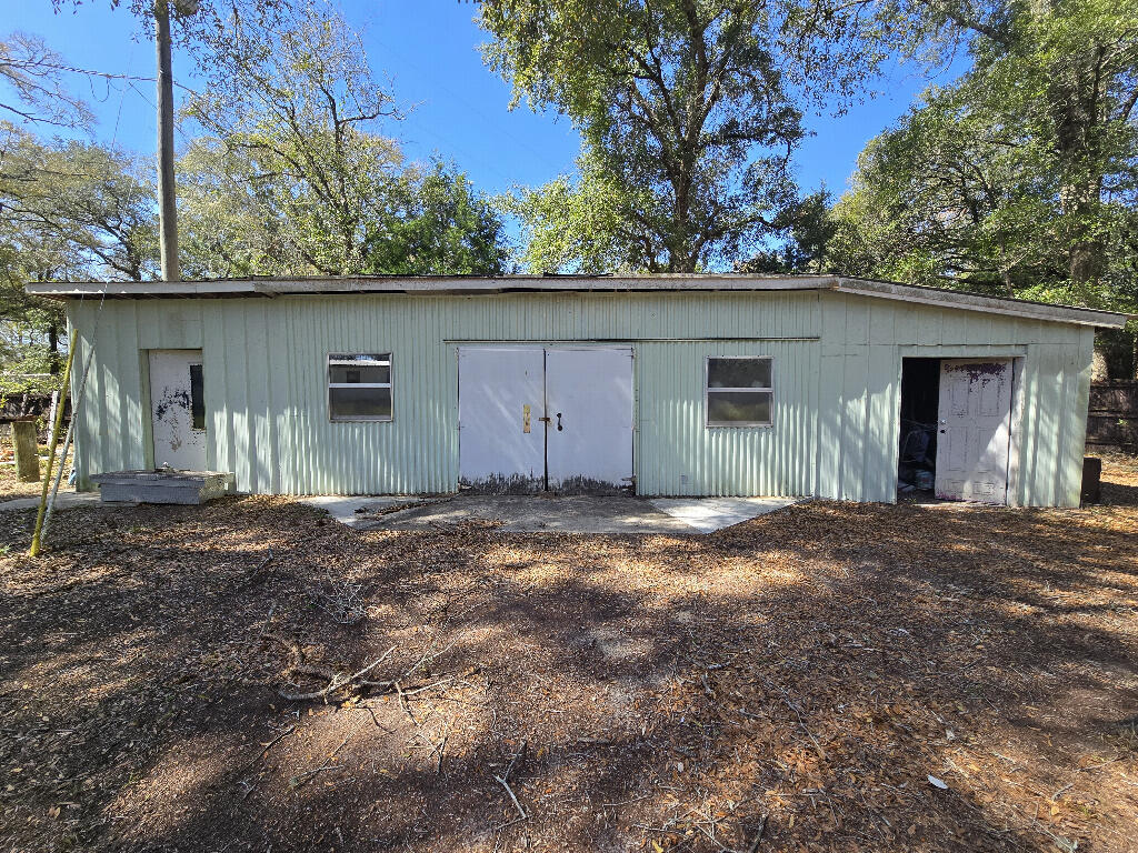 3 bed 2 bath manufactured double wide with a huge lot, large covered porch, utility room and dining room. Many new lights, rustic trim, bath fixtures and carpet. This house needs paint cleaning and some other floor covering. Older cabinets but usable. Fridge, stove stay with the home. Great to park an RV on too. Fenced rear yard. On 0.83 acres. Massive lot. This still has the ability to be fixed up but also a lot of equity potential. No roof leaks new sub floor in many areas, new floor covering in some spaces. Quiet nice area. 38 mins from destin. Contract sale available terms 95000, 15k down. 80k financed at 8% per annum. For 10 years . Monthly payment is 970.00To be seen you must have proof of funds.