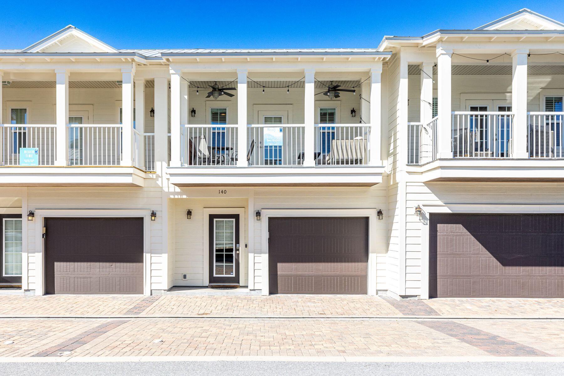 This attractive Destin townhome is ideally located--just three blocks from the beautiful beach and a stone's throw from local restaurants and activities. Boasting almost 2,000 square feet, this three-bed, two-and-a-half-bath home has a reverse floor plan. On the first floor, two large bedrooms and a shared bathroom comfortably accommodate family and friends. To the front of the property, you'll find paved parking for two vehicles and a single-car garage that provides storage for beach toys, bikes and paddleboards. A small porch covers the entrance door. The rear yard is a peaceful green space for barbecues, with a covered porch providing welcome shade. Head upstairs to the second-floor living space, where neutral wood laminate flooring and a shiplap wall complement the stylish plantation shutters, recessed lighting and coastal-inspired decor. The open floor plan flows naturally from the spacious sitting area through the formal dining space to the kitchen. Stainless steel appliances and granite countertops deliver a clean, fresh look to the well-appointed kitchen. A separate in-unit laundry room takes care of beach towels and additional storage. The second-floor master suite is at the rear of the property. It boasts a walk-in closet and a modern ensuite bathroom with a double vanity and a tiled shower-over-tub combo. The living room opens directly onto a generous 10-foot-deep balcony with pleasant views of the community pool. It's a delightful space for relaxing, reading and entertaining. As well as a pool, this friendly neighborhood has a dog park. Enjoy walking, riding a bike to Henderson Beach State Park or take advantage of the plethora of activities and restaurants that Destin has to offer. Big Kahuna's Water Park and the Destin Harbor are just some attractions nearby.