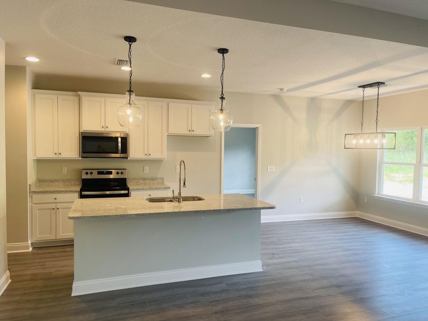 New Construction Home on over an Acre. Waterproof Laminate Throughout, Tile Shower, Granite Counter tops.