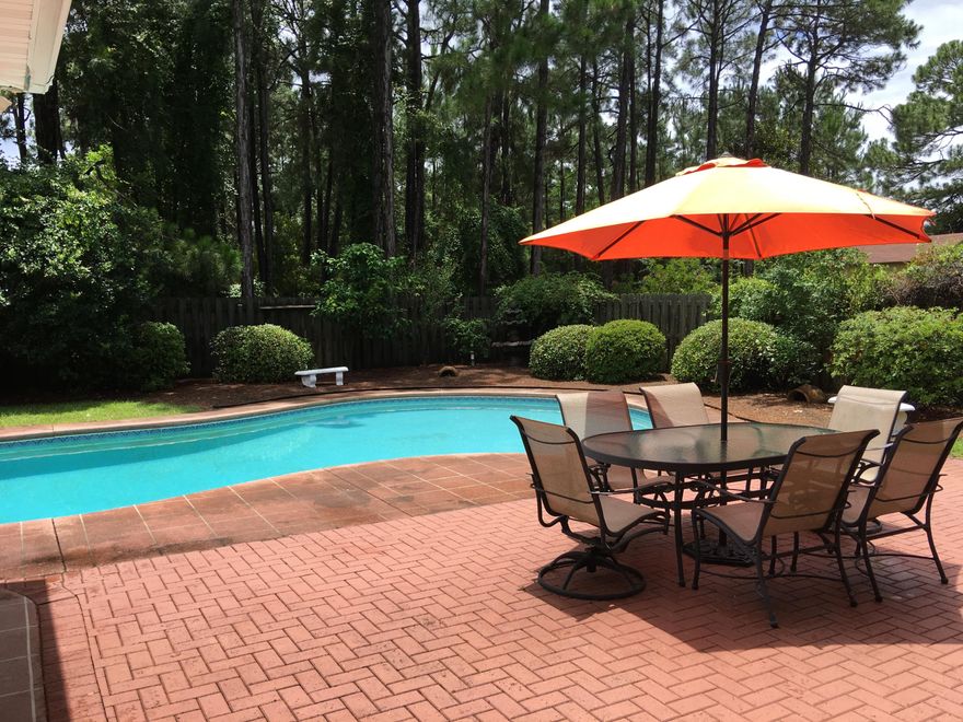 Just reduced again, priced to sell quickly on this lovely and spacious family home, sitting on a beautiful estate sized lot, and located on the very desirable street of Indian Trail, in Destin, right across from the bay! This is a custom built, 4 bedroom, 3 full bath, 2,470 sq. ft., rambling one story sitting on almost 1/2 acre measuring 100' x 200', and has been lovingly cared for by it's owners. The yard is lushly landscaped with a fenced backyard, and there is a large, heated swimming pool to enjoy year round. This home has the popular split and open floor plan, with grand foyer entrance, 10 foot ceilings throughout, crown moldings, hardwood and tiled flooring with carpeting in three of the four bedrooms for added coziness.