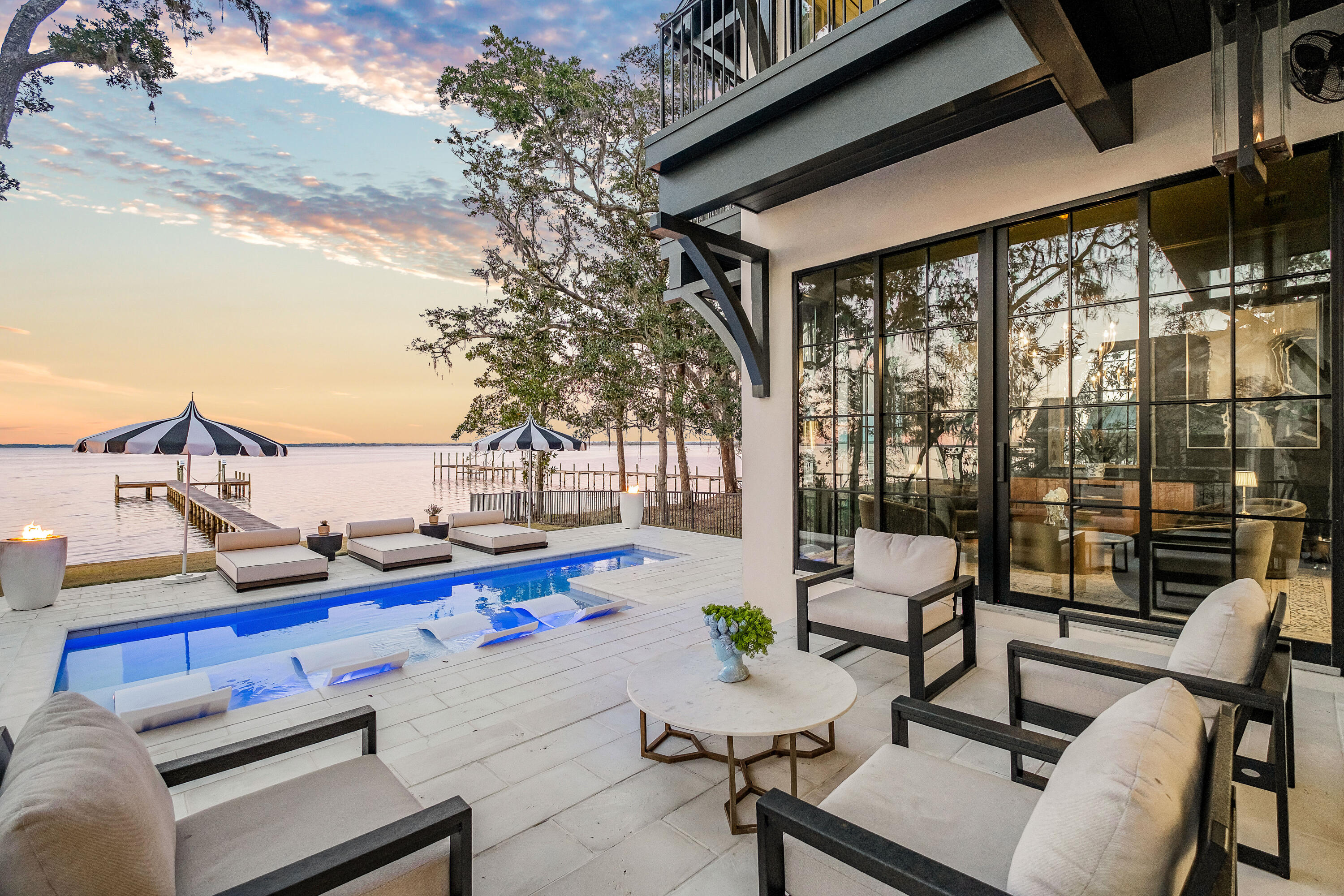 This exceptional custom-built home sits on a generous bayfront wooded lot in the exclusive Magnolia Beach neighborhood at Point Washington. From the lighted dock and private boat slip to the exquisite herringbone wood flooring, no detail was overlooked when this home was built. A serene terrace with outdoor fire features and a private heated saltwater pool provides the perfect place to relax and savor uninterrupted bay views to the horizon. Inside this timeless home, you'll find endless subtle features to please anyone with an eye for detail and design. Refined touches include Andersen windows, sturdy 1.7-in. bolection molding doors, 10 and 12-ft. ceilings, and deep baseboards. The spacious foyer invites you to pause and take in the dark hardwood flooring and the breathtaking staircase as it winds upwards to the second floor, illuminated by custom star chandeliersa stunning focal point.

Warmed by a gas fireplace, the main living area is flooded with natural light as multiple windows frame stunning views of the blue bay waters. Tucked away beside the living area, a dedicated office provides a quiet space to work while still enjoying glimpses of the serene landscape. A hallway off the foyer leads to a half bath and a gracious master bedroom with its own private bathroom.

Turn toward the gourmet kitchen, which boasts a generously sized bar for dining while taking in beautiful bay views. Marble counters add grace to the kitchen area, which features custom cabinetry, twin sinks, and upscale appliances that combine functionality with modern style. An open doorway leads seamlessly into a butler's pantry, complete with another sink/wet bar for preparing drinks and canap??s. Cupboards and shelves provide ample hidden storage for everyday appliances. A cozy sitting nook offers stunning bay views through floor-to-ceiling windowsan idyllic place to relax and enjoy your favorite playlists after dining with family and friends. Sonos surround-sound speakers and color-changing lights create a harmonious ambiance when entertaining indoor and outdoors.

The second floor features three more beautiful bedrooms, each with spa-worthy private baths. The primary suite is particularly noteworthy, with 14-ft. cathedral ceilings and french doors that open to a private bayfront balcony. The vast marble master bath features a soaking tub, a separate steam shower, and a lengthy twin vanity. The bathroom opens into a fully fitted dressing room with endless custom shelves, drawers, and hanging space for impeccable organization. The upper hall and two bedrooms have direct access to a bayfront terrace, offering a peaceful space to sip a cup of coffee or enjoy quiet contemplation before the day begins. A second-floor laundry room rounds off this well-appointed home.

Additional features include a security alarm system and an energy-efficient tankless water heater. Situated on a spacious half-acre lot, the long driveway provides ample privacy and accommodates parking for at least four vehicles. A carriage house with a carport is planned for addition, with options to add customizations to suit your needs. Located in a family-friendly neighborhood with no HOA restrictions, this property offers both versatility and potential for expansion.

Located close to the coveted 30A corridor, this waterfront home is superbly situated for boaters and fishing enthusiasts to enjoy the bay and tranquil surroundings while remaining within easy reach of top restaurants, boutique shopping, and entertainment. Beach lovers are just minutes away from the white sands of Grayton Beach, while hiking and biking opportunities are plentiful in nearby Point Washington State Forest.