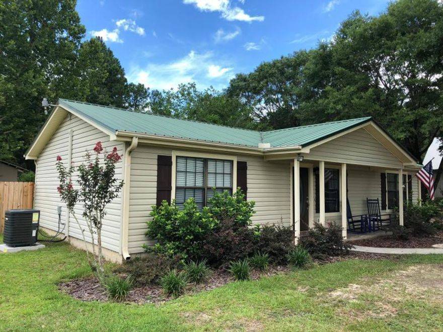 This well-maintained home is located in south Crestview on almost one acre! Welcome home to your long a private drive with detached garage/workshop and barn building. Super cute living space with updated lighting and updated interior panel doors and you'll find 3 bedrooms and 2 full bathrooms. Tile flooring throughout - no carpet! The kitchen Stainless steel appliances and white cabinets line the separate galley-style kitchen which leads into a separate laundry room with further storage. The fenced backyard offers shade from trees and nice open space for sunshine too plus a great sized deck off the back door! The easement next to this property was previously leased from Gulf Power for horses -to be verified by buyer.