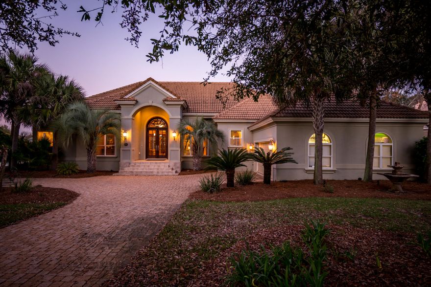 From the moment you enter through the double mahogany doors, you'll see no detail has been over looked. This 3 Bedroom, 3.5 bath lakefront home in Regatta Bay offers an open, split floor plan with a fantastic kitchen... gas cook top, wall oven, breakfast bar, island & desk area. The master suite offers his / her vanities as well as walk in closets. The den / family room is a relaxing retreat with plenty of built ins & gas fireplace. The backyard & patio offers an oasis with privacy, heated screen pool, lush landscaping & a manicured landscape with views of almost 200 ft of lakefront with glimpses of the bay. A few extras include tile & hardwood floors through out, granite counter tops & golf cart garage. Views & pool access are all featured from the den, living room & master bedroom.