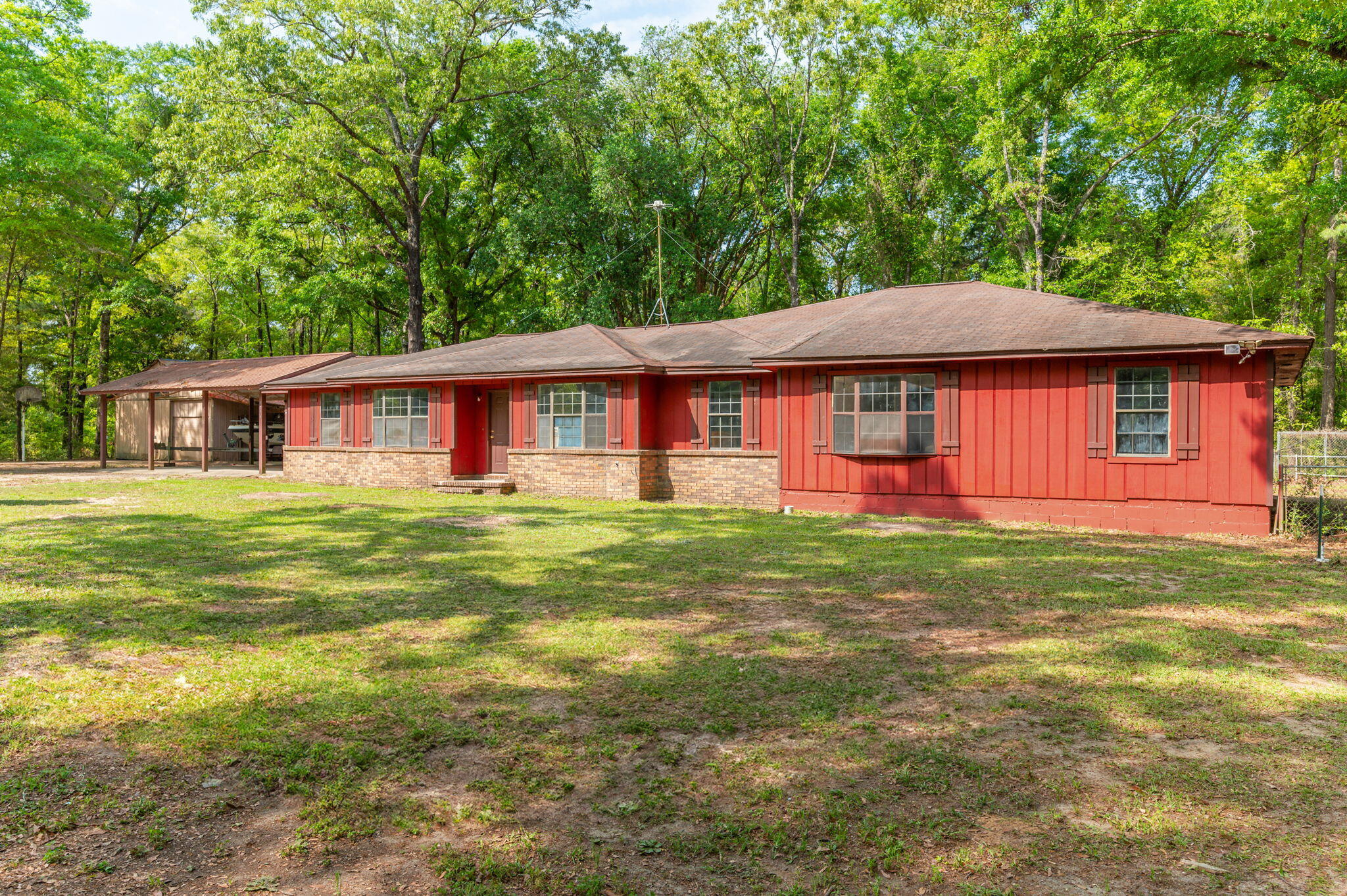 Sellers offer a NEW ROOF at closing with an acceptable offer on this 6 bed/3bath home that brings spacious country living. Approx. 10 min. from shopping and schools. Property is mostly wooded 1 acre for that secluded country feel. New HVAC installed in 2022 and 2 tankless water heaters installed in 2023. Fireplace in the living room, wallk-in pantry and spacious laundry room. tile flooring throughout the home (no carpet). Stainless steel appliances-Microwave (2019), Dishwasher & fridge (2020), stove(2022) and the washer and dryer all convey with the home. Plenty of beautiful wood kitchen cabinets. With a large garage/workshop and a 3 car carport this home is a must see.