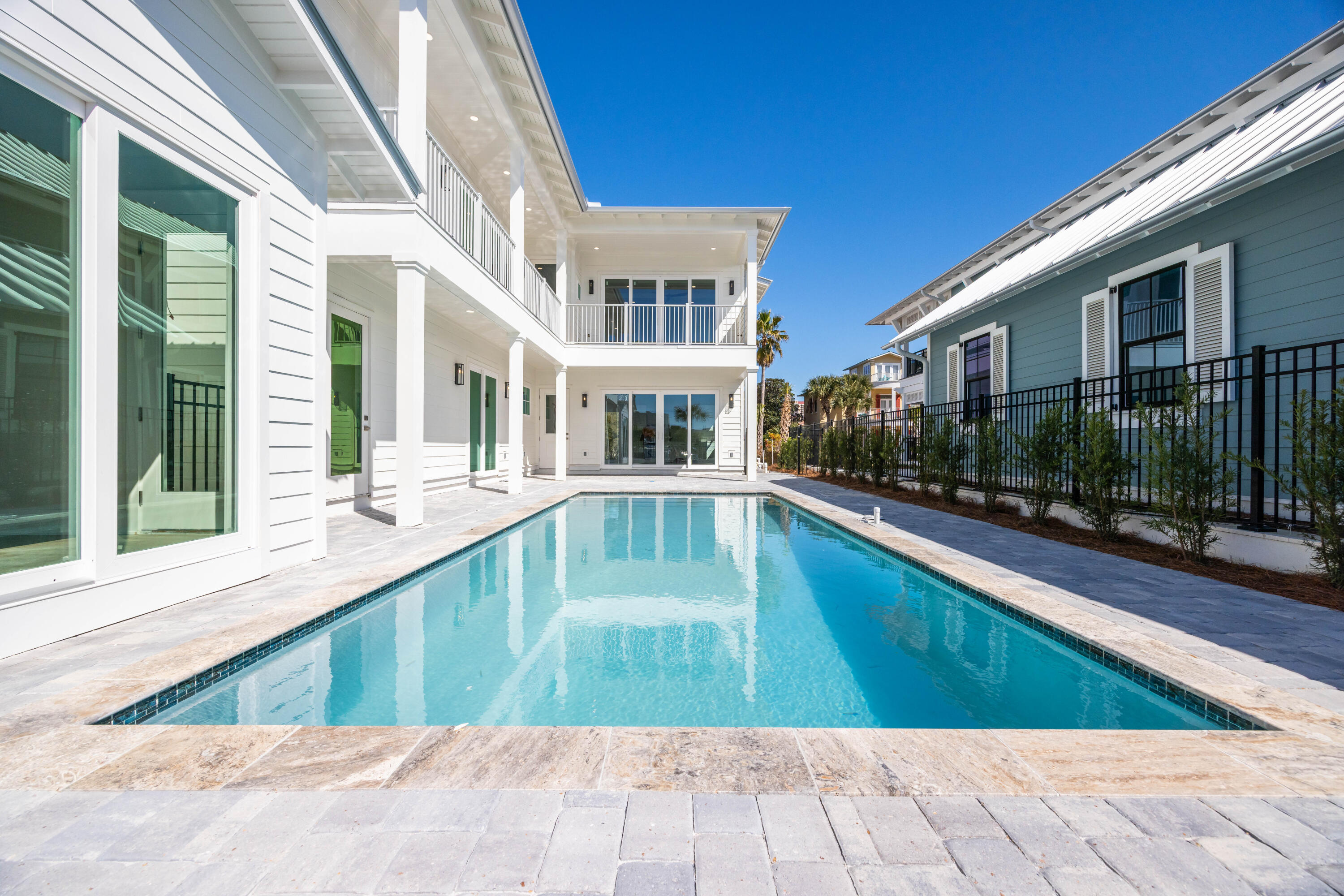 Nestled in the gated beachside community of Caribe, one of the most prestigious private retreats in Miramar Beach, this masterpiece expertly blends Caribbean styling with modern livability. Built on an elevated lot in Caribe steps from the beach access, this floorplan has been expertly designed to capture the views and natural light where you expect them most. The front entry invites you in to find a fabulous gathering space, with high ceilings and plenty of natural light. It is here that you will also find this home's three guest bedrooms, perfectly sized with comfort and tranquility in mind. From this main floor, you'll find access to the large saltwater pool and carriage house. Heading upstairs, you'll find another perfect entertaining space. The open floor plan seamlessly connects the large, light-flooded great room with the entertainer-chef's kitchen while the walk-in pantry and large dining space are perfect for your gatherings. Large doors open out to the patio creating a perfect indoor/outdoor experience. Venture further and you'll discover the restful master oasis that is set between two large windows, perfect for capturing the daytime sun or the glow of the evening sunset. The master bath is thoughtfully designed, with a beautiful walk-in shower, double vanity, private lavatory room and light-filled master closet. Continuing to the third-level covered tower where you can further extend your views while enjoying the Gulf Coast's blue skies and gorgeous sunshine. Throughout the home, expect durable, high-end finishes, with neutral beach tones accented by beautifully colored tiling. The luxury of this residence neither begins nor ends with the home itself. Entry to the community is gated with monitored security. Common areas are lusciously and meticulously landscaped with mature trees carefully dividing the quiet roads. Tennis courts, community swimming pools and two deeded beach walkovers, all set against a beautiful private beach, make Caribe an amenity-rich oasis. This tropical paradise experiences little to no impact from surrounding amenities yet is mere minutes to them. Venture out to find some of the finest shopping, dining, and entertainment in the area with a quick escape back to your private haven when it's time to relax again. Be it a primary, vacation, or investment property, increased interest in the area, coupled with such a sought-after address, make this a rare and not-to-be missed opportunity to put your personal touches on the home you've been dreaming of.