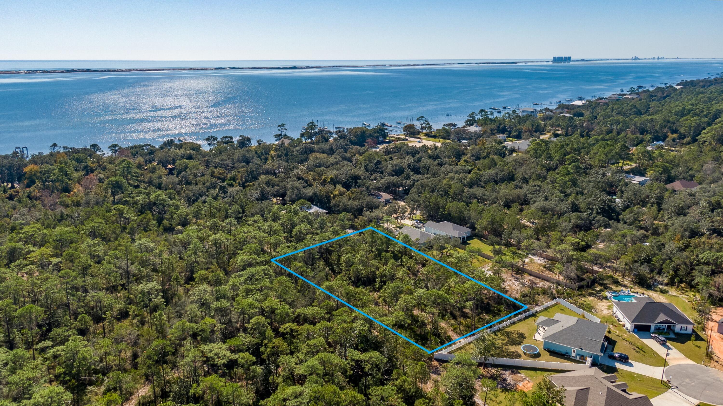 Welcome to Woodlawn Beach located in Gulf Breeze, FL. A nice developed neighborhood centralized to Downtown Pensacola and Navarre Beach,FL. THREE Platted Lots located South of Hwy 98 and Woodlawn boat Launch. Lots 1,2,3 Woodlawn Beach. Each Lot is .4 acres or 60'X289'. The boat launch is well maintained with more than adequate parking for the community. The lots are private and serene for peace and quiet and there is NO HOA here. Property to be sold as one. All information deemed to be accurate as Buyer to perform due diligence.