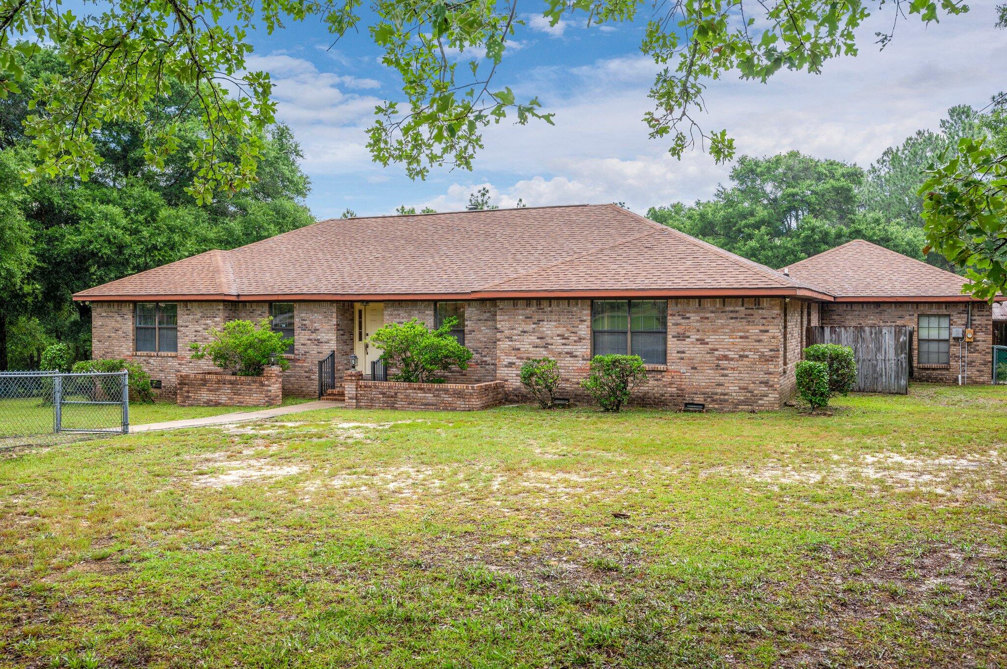 Have you been looking for a home with land, a pool, and a place to park your RV? Then look no further and come check out your new home! This 3 bedroom/3 bathroom home (+ an office) is sure to please! * Seller's are even offering a $4,000 FLOORING ALLOWANCE to buyers so you can upgrade to whatever flooring you'd like!* The living room has PLENTY of space and features a wood-burning fireplace! The kitchen also features a kitchenette that overlooks your screen room and in-ground pool. You will LOVE the size of all the bedrooms in this home, as well as the laundry room! The laundry room also features the 1/2 bath and a door that leads to the back deck (this is a perfect area for guests to use the bathroom if you have a pool party).