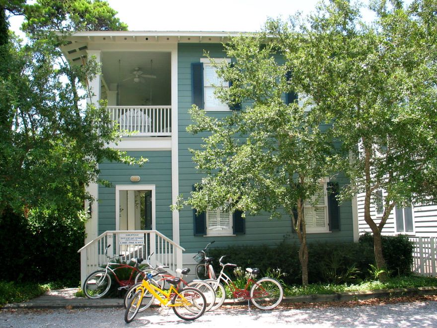 Entered for comparable sales.
Southern living at its best. A pleasant surprise awaits you behind the entrance door of this Charleston style cottage. Side porches run the full length of the cottage on both levels, each are lined with four sets of French doors. The ceiling of the living area rises through the second level and filled with sunlight from the double set of windows with transoms above. Built in book shelves are flanked by the French doors. The kitchen and dining areas are separated by a breakfast bar with classic Tuscan order columns. The kitchen is painted a crisp white and features glass window pane upper cabinets, tile countertops, butcher block island table and crown molding. Natural finished oak floors and crown molding used throughout the cottage highlight the architectural details of this cottage