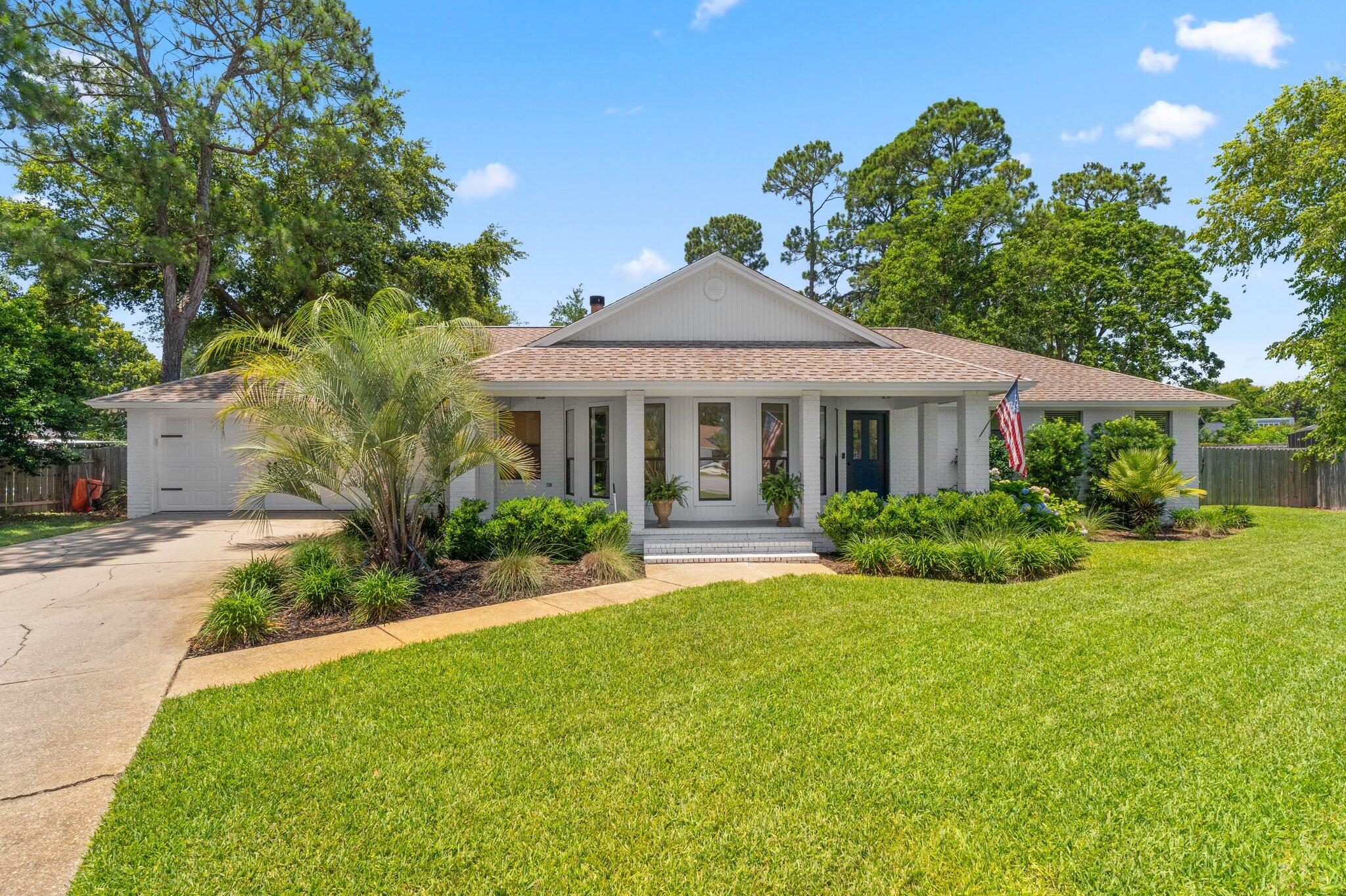 Welcome to this beautiful 4 bedroom, 3 bath home. Perfectly situated on a cul de sac in Tiger Point Village, this home has loads of recent seller updates, including the inground pool that completes your very own backyard oasis, ready for endless outdoor entertainment for your family and friends. Or grab your clubs and take them to the Tiger Point Golf Club to hit the green! Entering this split floorplan home, you're greeted by the beautiful natural light that pours into the space from the bow windows in the living room that look out to the front porch. Recently installed LVP flooring throughout the common areas, primary bedroom, and guest bathroom. Featuring an updated kitchen with stainless steel appliances and the newly installed shiplap on the kitchen bar for that modern coastal touch.