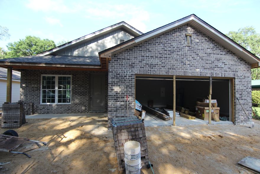 New 3 bedroom 2 bath home in the center of Niceville. This home consists of a brick front with hardi board siding. The open floor plan allows for ease of entertaining! The kitchen has granite counter tops, stainless appliances, wood laminate flooring and crown molding. The living room, dining room and kitchen all have crown molding. All the bedrooms will have carpet flooring and ceiling fans. The master bathroom includes a garden tub, a separate shower, double vanity, and tile flooring. Off the dining room is the covered back porch to enjoy the Florida weather. This home is close to the college, Eglin Air force Base, and the award winning Niceville Schools. Construction estimated to be finished mid May 2016