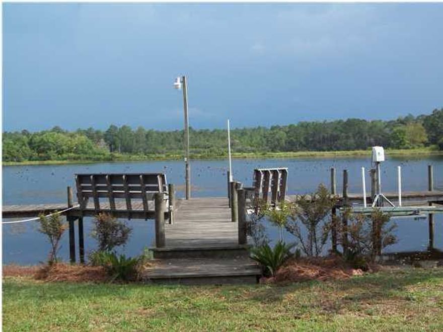NO ASSOCIATION DUES!!!!PRIVATE, LAKEFRONT HOME WITH WONDERFUL NEIGHBORS PER THE SELLER....FISH IN THE APPROX. 700 ACRE LAKE JUNIPER FOR CATFISH AND BASS, THEN RELAX IN THIS OPEN FLOOR PLAN, 3 BEDROOM/2 BATH HOME WITH SPACIOUS SCREENED-IN BACK PORCH WITH LAKEFRONT VIEWS THAT ARE AWESOME . ........TWO SEPARATE DOG PENS SIDE BY SIDE WITH DOGGY DOORS. .... ONE OF THE MOST PEACEFUL AREAS AROUND. ....... WOULD ALSO MAKE A WONDERFUL RETIREMENT COTTAGE, CLOSE TO THE BEAUTIFUL BEACHES OF SOUTH WALTON AND DESTIN...(APPROX. 40 MINS.)...LOT NEXT DOOR AVAILABLE FOR PURCHASE WITH PROPERTY..... MOVE-IN READY. PROPERTY TO BE SOLD ''AS IS''. Wal-mart and High School are approx. 10-15 minutes away. Note: Refrigerator, washer and dryer do not convey.