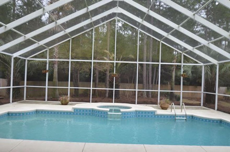 PARADISE FOUND! You MUST see this beautiful hidden retreat/paradise! The large screened enclosure features a beautiful heated in-ground pool and jacuzzi. The backyard is an absolute oasis! It features a large deck with picnic tables, gas grill and shade for entertaining all of your family and friends. The backyard has privacy fencing and to the back of the lot is green space. Landscaping includes palms, flower beds and trees. The home itself is an invitation to comfortable living. The kitchen, eat-in area and an entertainment area all look out onto this beautiful pool area. The kitchen features all appliances including refrigerator, a breakfast bar and pantry. The house has a wonderful flowing floor plan that includes a master bedroom with two walk in closets and an ensuite. MORE!