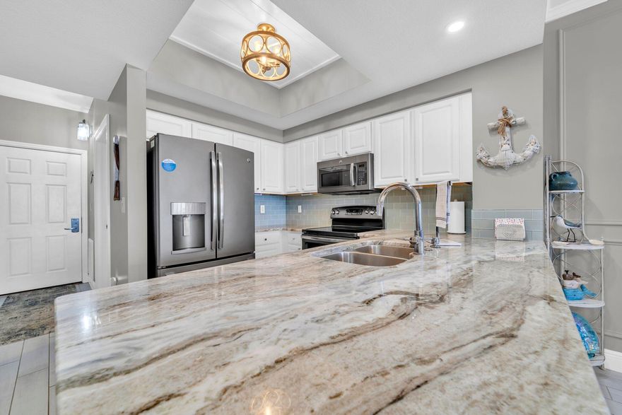 As you enter this stunning condo, you will immediately feel the warm mixture of classy and coastal.  These owners have put so much thought and beauty into all the upgrades.  From the tile floors, wainscoting, tiled showers, granite countertops in kitchen and bath, bunk beds and king bed in guest bedroom, lighting, soft close shades and furnishings, this is truly a beautiful place to make memories with friends, family,  a second home or would be a great rental property.  The oversized balcony takes you one step further to the outside elements by embracing the views of the white sand beaches and emerald green waters .  Please see list of upgrades in our documents.  Full size washer and dryer 6 months old. Truly a piece of paradise, this could be yours!  Call me today