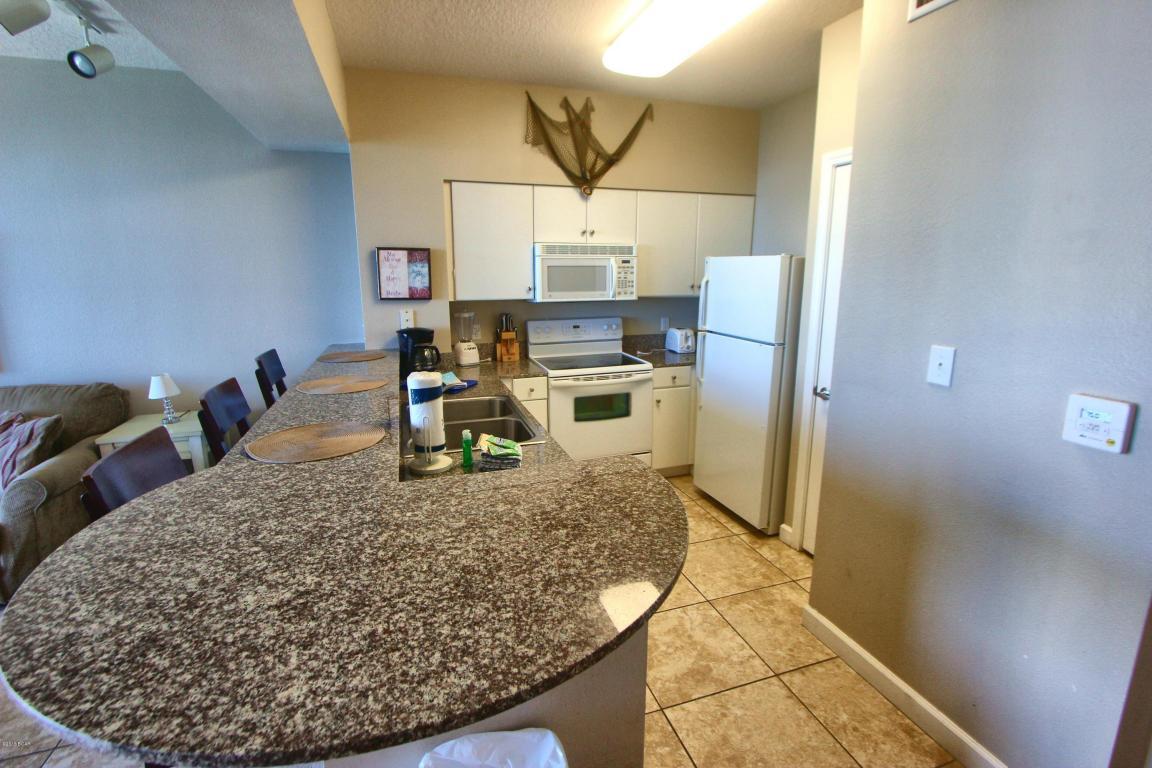 Tiled/hard surface flooring throughout. Dedicated/Private Parking Space. Best Value on the Beach! The beach getaway you've been dreaming of at the super popular Shores of Panama! Highly desired Type J floorplan features master bedroom on the gulf and conveys with private parking space #457. This beautifully decorated, beach inspired 2 bedroom + bunks, 3 bath Gulf front condo is tiled throughout and fully equipped for rental and has a seasoned rental history. Easily sleeps 8. Riveting Gulf views are framed by decorator perfect interiors, designed with the beach and sun in mind. Sunshine and warm gulf breezes abound from the balcony, with amazing Gulf views. The gourmet kitchen features loads of cabinet space and is fully stocked and rental ready.