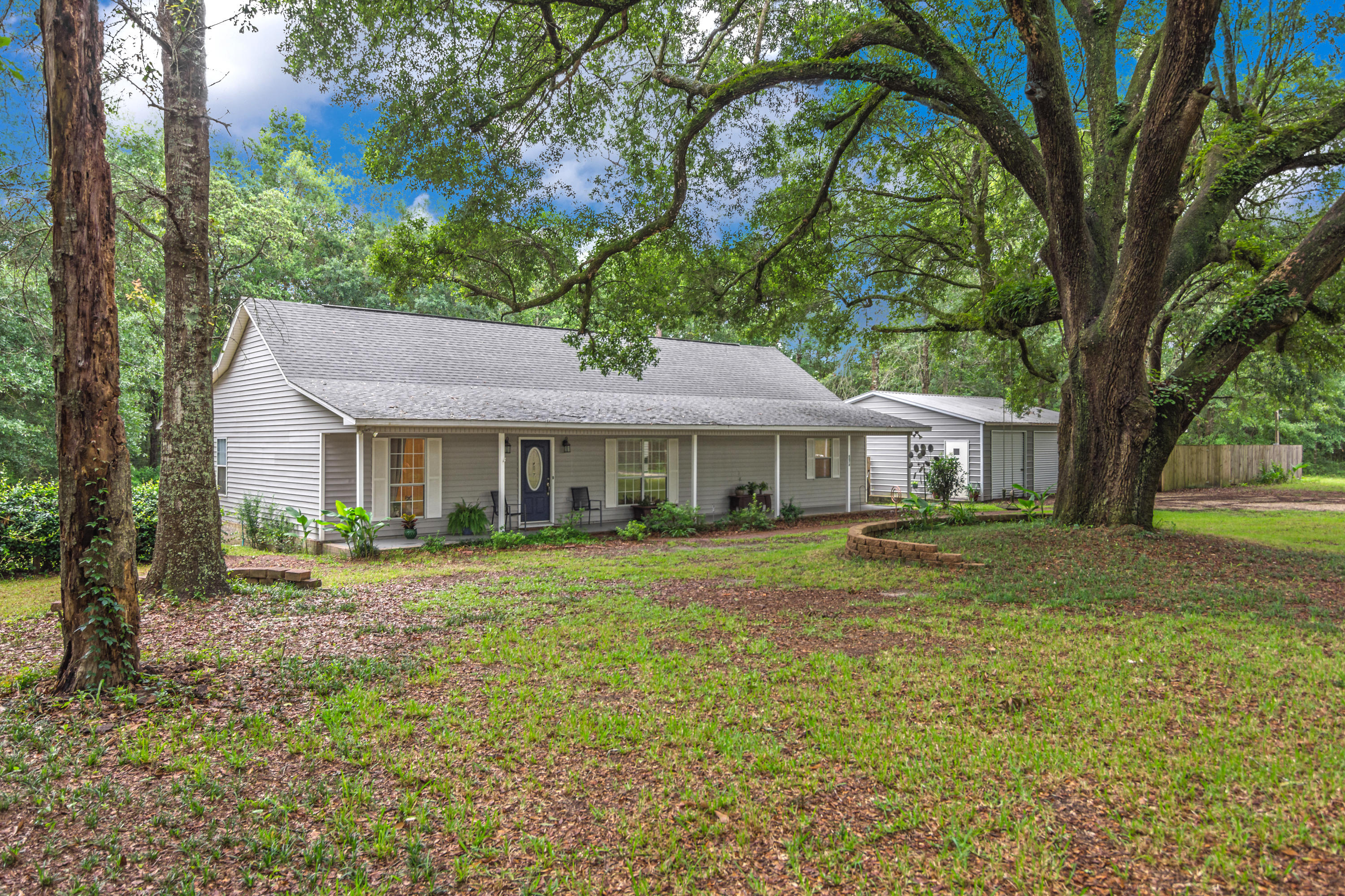 BACK ON THE MARKET. NO FAULT OF THE SELLER.This 2 acre country setting home is ready fo you to move in. It is a 3 bedroom 2 bath with a detached 2.5 car garage! Plenty of room for you to tinker in! The master suite is oversized and has it's own office/sitting area for you to enjoy your serene surroundings. You can walk out to your back deck and enjoy your morning coffee from your master suite. If you enjoy rainy afternoons, this home has the perfect front porch for you to sit and relax. The living room is spacious with vaulted ceilings. 2nd smaller yard barn and water filter contraption on the other side of large garage are considered as is where is and no warranty.