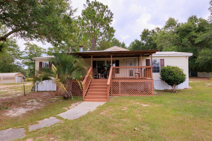 Peaceful, private, and quiet country living on 10 beautiful acres! Perfect for ATVs, horses, and other outdoor sports. Wooded area of the property offers many trails for fun & exploration. Property has fenced areas for pets/livestock. Spacious double wide with open floor plan, split bedroom design, high vaulted ceiling, eat-in kitchen. Primary bathroom features separate shower and bath. Beautiful covered front porch. Covered aluminum 2 car carport, large workshop with double doors & electricity. Separate storage building behind workshop. Electrical hookup for RV on property as well. Proceed with caution along Carousel Ln and driveway. Vehicles with ample ground clearance recommended.