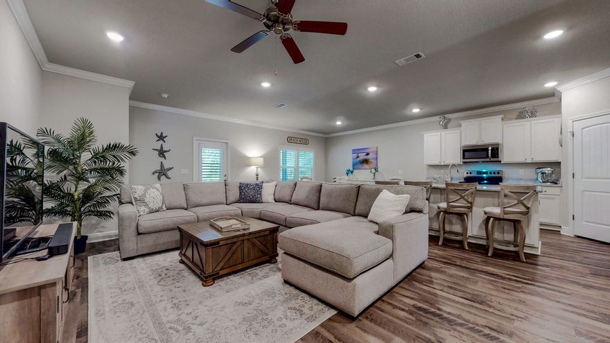 Cozy looking on the outside but roomy on the inside! 2049 sq. feet of gracious living space and wonderful upgrades including a screened rear patio, rain gutters and plantation shutters throughout. The large garage even has it's own separate heating and cooling system! There is plenty of room to entertain or just kick back and enjoy the space. The kitchen, living room and dining area are all open to each other and the kitchen has lots of storage, cooking and food prep space, plus a large walk in pantry. The split floor plan affords plenty of privacy to the four bedrooms. The master suite features a luxurious bathroom. A second full bathroom is centrally located to serve the rest of the home. LTV flooring throughout, no carpeting. Outside, the rear of the large back yard is bordered by