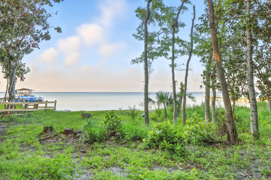 Welcome to your own piece of paradise! This incredible vacant land offers you the opportunity to enjoy waterfront living on the beautiful Bay, in one of the most desirable areas of Destin. The mature oaks, pine, and magnolia trees provide a natural privacy buffer creating the perfect setting for your dream home. Imagine custom-building your home and boat dock, taking in the stunning views of the bay, and enjoying excellent boating proximity to Crab Island, the Harbor district, and the Gulf of Mexico.  This location offers so much more than just a beautiful view! You can enjoy a wide range of activities, like kayaking, paddleboarding, fishing, dolphin watching, or simply basking in the gorgeous sunrise and sunset views that the Bay has to offer.  See some building plan options in photos.