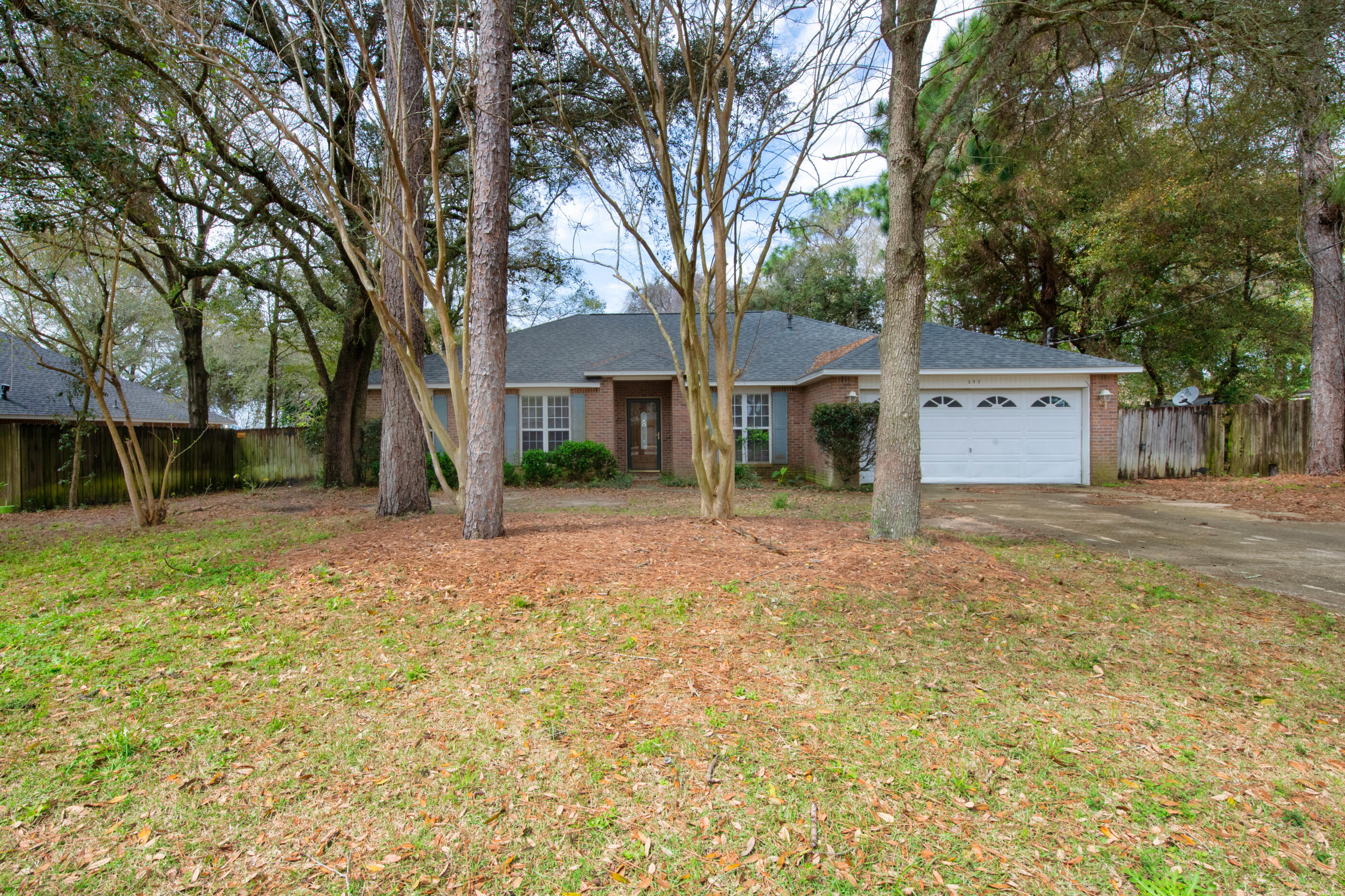 BRICK HOME WITH NEW ROOF.. NOW AVAILABLE.. AND THIS ONE WILL SOON HAVE A NEW WATER TANK AND ELECTRICAL PANEL! This 4BR/2 Bath ranch sits on a level lot, in south Crestview.. surrounded by mature trees.. with a fully privacy-fenced backyard. Inside, you'll find more than enough space for large family gatherings (1920 sf). There's a formal dining room with wainscoting.. a spacious greatroom with fireplace.. a gas-equipped kitchen with island and pantry.. a large breakfast nook.. and the owners recently installed new ''wood-look'' tile flooring. The spacious master suite is carpeted, with more decorative wainscoting, and a deluxe-sized walk-in closet. The master bath features a separate tub and shower; along with a double vanity. All remaining bedrooms are large with roomy closets. (continued)
