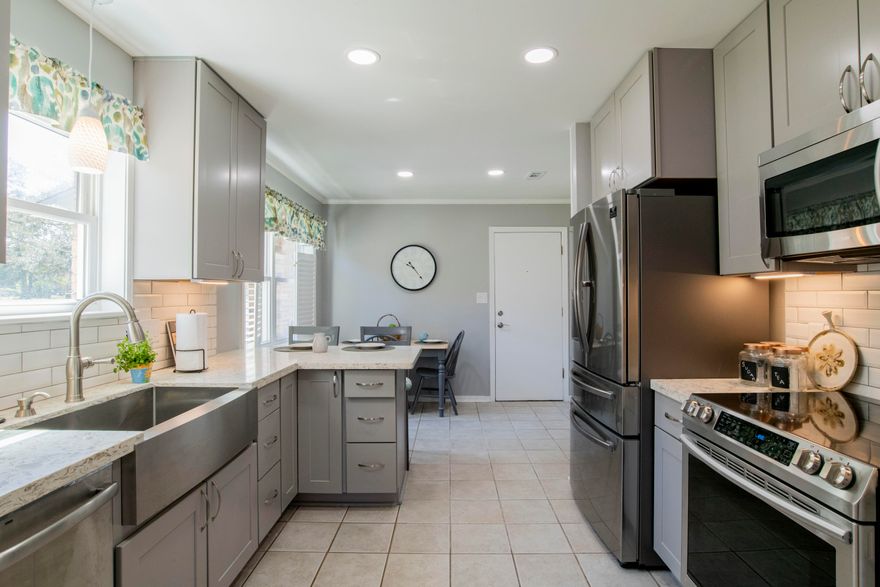 Nestled in the wonderful neighborhood of Bay Cliff Estates, this renovated 3 bedroom 2 bathroom home has so much to offer! Upon arrival, you'll notice the gorgeous pavers in the driveway and that it's located directly next to the neighborhood park. The kitchen has been newly remodeled with brand new soft close cabinetry, Quartz counter tops, back splash, Energy Star Qualified stainless steel appliances, recessed lighting and farmhouse sink. It also comes fully equipped with a pantry, formal dining room , breakfast bar and breakfast nook. Just off the formal dining room is the spacious living room with vaulted ceilings with wood beams for added charm and a wood burning fireplace. You'll also enjoy the large screened enclosed patio which ope