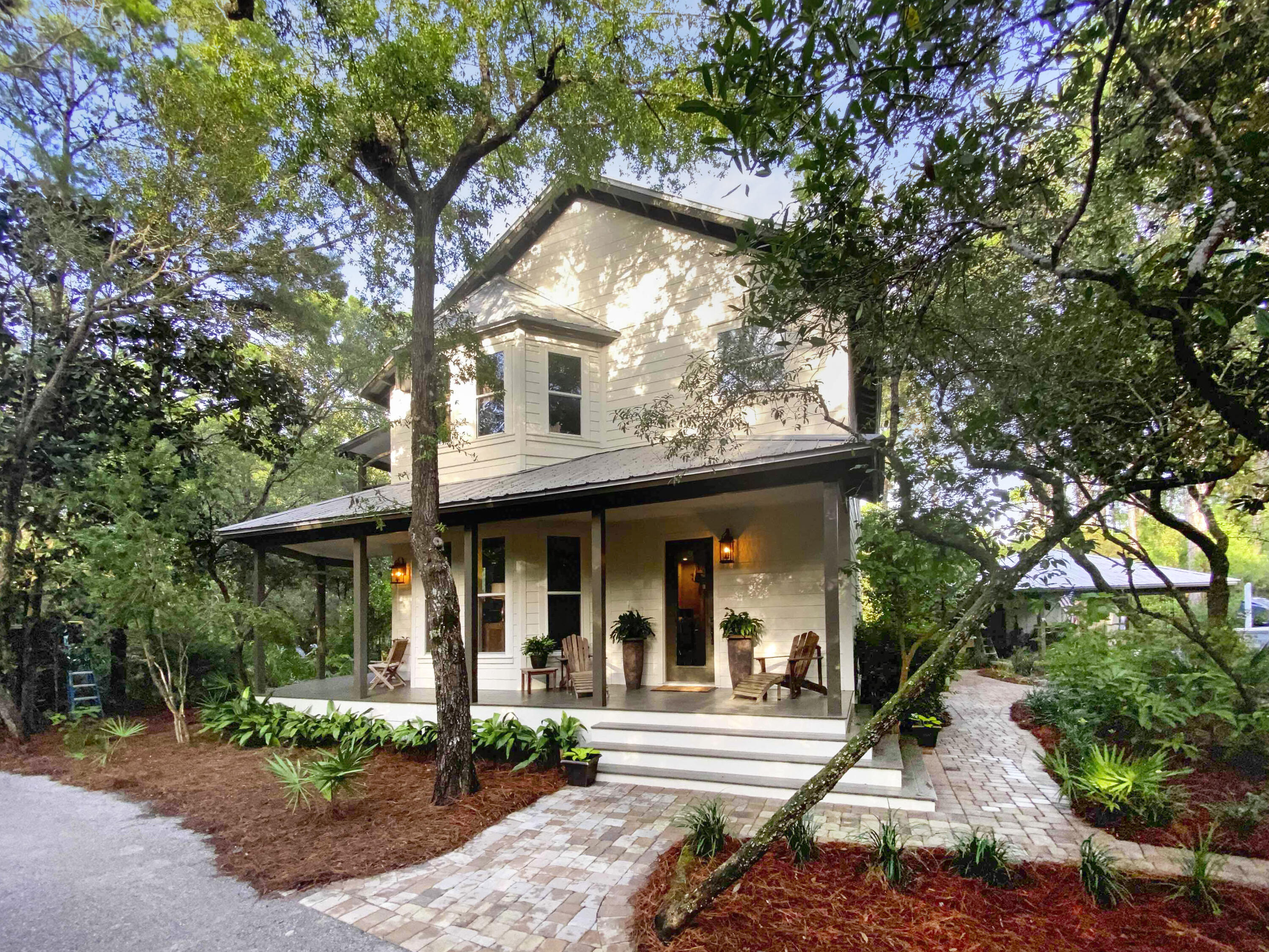 Beautifully renovated Florida Cottage in Bay Magnolia with wrap around covered front porch.  Sitting on 1.2 acres and surrounded by mature oaks and magnolias, this home offers plenty of privacy.  The large, double entry driveway offers ample parking, room for an RV or boat, as well as a 2 car carport with extra storage.  The renovated kitchen offers all new appliances and flows wonderfully to the oversized screen porch leading to the backyard.  A great place for family dinners or entertaining.  The second floor features 3 bedrooms.  The oversized master bedroom with private balcony offers a bathroom with spa tub and separate shower and double vanity sink.  The 2 guest bedrooms share a jack and jill bathroom.  Bay Magnolia features a community bay front park & dock and only 44 home sites.
