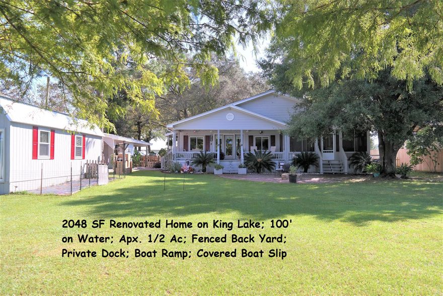 This beautifully renovated home on King Lake is an absolute must see! Home sits on 1/2 ac w/ fenced back yard; private boat ramp, dock, covered boat slip; 16x32 detached, air conditioned shop & office building; 10x18 storage & garden shed; irrigation system. Interior features open floor plan; split BRs; Fireplace in master; Both baths renovated; large laundry/utility room; Custom kitchen cabinets with low-maintenance, recycled glass countertops; soft close cabinets/doors. Beautiful lake views from kitchen, living/dining & master BR; Master opens onto screened porch. 10x48 covered porch & screened area spans the entire lakeside of home for some of the most beautiful sunsets you can imagine! There are too many amenities to mention so schedule your showing today...you won't be disappointed!!