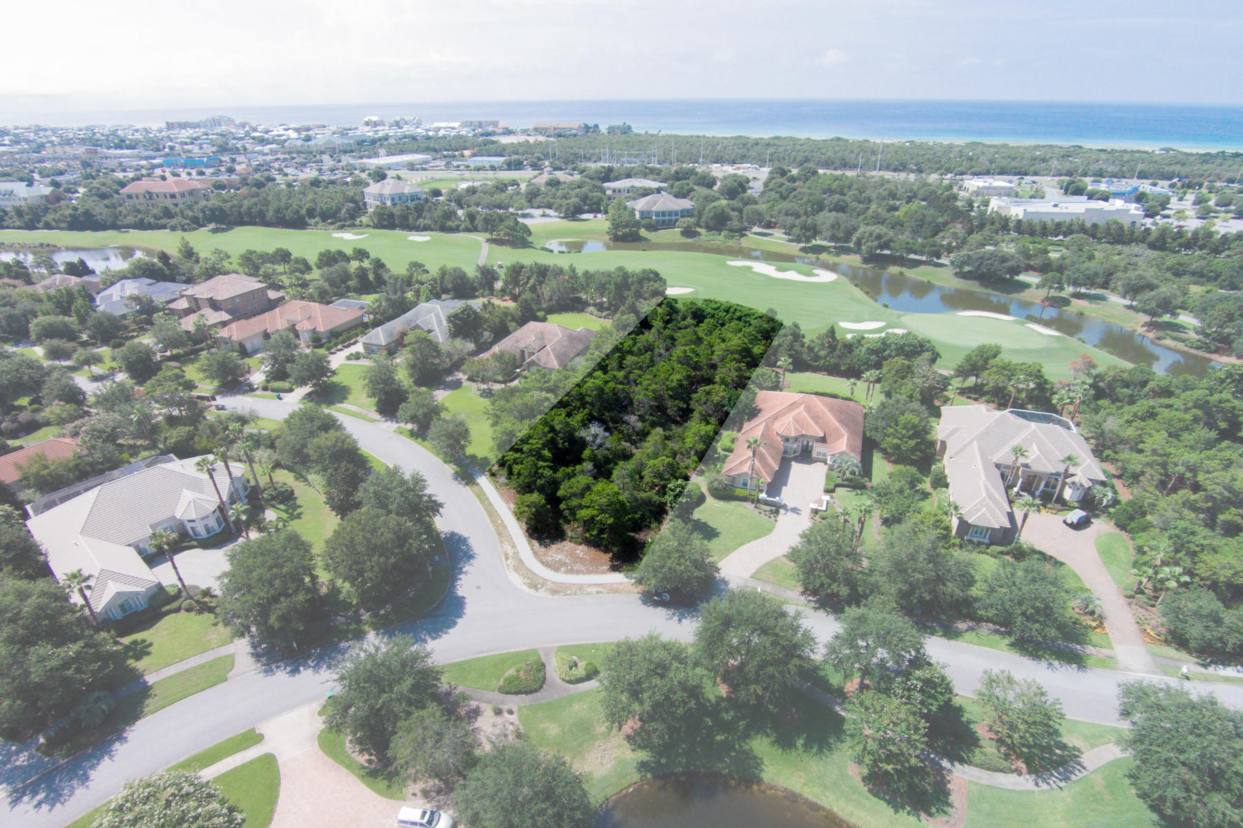 At nearly three quarters of an acre, this lot backing up to the 13th fairway of the Fred Couples and Gene Bates-designed Kelly Plantation Golf Course not only enjoys a prominent location, seen across the fairway upon passing through the main, gated entrance to Kelly Plantation, but is also among the largest vacant golf course lots that remain in this 900-acre country club community. Flood insurance is not required thanks to its desirable X flood zone rating. The property will convey with a set of plans for an insulated concrete form construction home with 4,205 square feet of living space, an additional 512 square feet of bonus space, as well as a 1,216 square foot lanai.