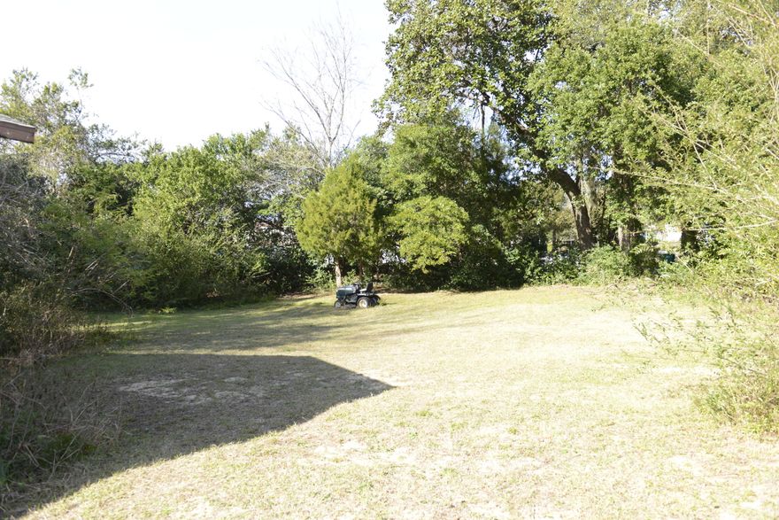 Bordering the Turkey Creek area this 1.5 acre lot hosts stunning scenery, and wildlife. The land is currently uncultivated and most of it is covered in trees. It starts level to the road and has a gradual slope downhill into a flat plain before hitting the tree line. The lot also has a three bedroom two bath house which is either a handyman's dream or a tear down. There are also three sheds closer to the road. Surrounding properties are town homes. The lot is perfect for development. The property is zoned R-3, multi-family. This zoning allows for 15 dwellings per acre, however, City of Niceville has advised that 15 townhouses probably will not fit on this land due to some wetlands at the rear of the property. A wet land survey would be needed. Seller does not have one on file now, only a regular survey.  If building single family homes, in the R-3 zoning, you can have approximately 5 homes on 40' lots. The lot size would be approximately 40 x 100 +/-. Other restrictions could apply.  According to the tax roll it shows a small triangle piece across the street from the main parcel that does not convey with the main parcel, Seller committed that piece to the buyer of the mobile home.  Please do not rely on the entire legal description. MLS number for the residential side of the listing can be found at #838410.