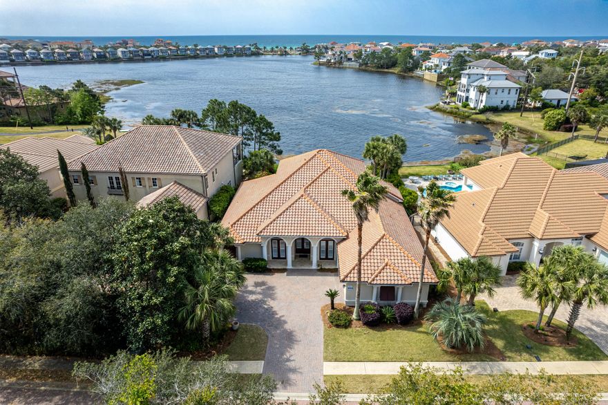 Welcome to this stunning lakeside retreat offering the perfect blend of luxury and tranquility. Nestled along the serene shores of the lake, this magnificent property boasts a spacious layout with four bedrooms and three baths downstairs, complemented by three bedrooms and two baths upstairs to allow for ample space for everyone. As you step inside, you'll be greeted by a grand foyer that leads you into the heart of the home. The main level features an expansive living area, ideal for entertaining guests or relaxing with family. With ample natural light streaming in through large windows, every corner of the house is bathed in warmth and brightness. The gourmet kitchen is a chef's dream, complete with high-end appliances including a gas cooktop range with double ovens. Adjacent to the kitchen, the dining area offers picturesque views of the lake, making every meal a delightful experience. Conveniently located on the first floor with patio and pool access, the primary bedroom provides a peaceful sanctuary.  Each guest bedroom is thoughtfully designed with comfort and style in mind.  Step outside to discover a private oasis perfect for outdoor gatherings, featuring a lake-front pool and hot tub.  Whether you're lounging by the pool or watching the game fireside with friends, this backyard paradise is sure to impress. With its prime location and Destiny East's desirable amenities, including a large pool, two lighted tennis/pickle ball courts, a clubhouse with a gym, party room and theater, this home is a rare opportunity.  Whether you are seeking a second or primary home or investment property, this incredible property is sure to exceed your expectations. 