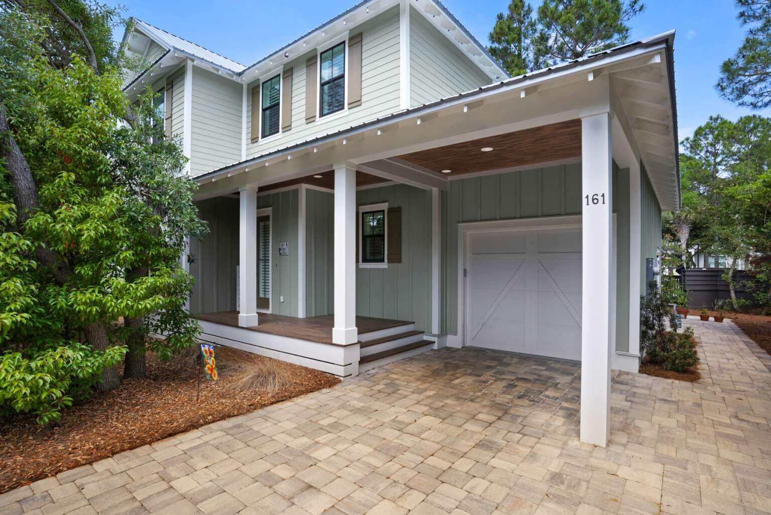 With a mix of private comfort inside and immediate access to a variety of natural wonders outside, 161 Lakewood Drive is ideal as either a primary home or secondary vacation home. Located in Seagrove Beach's Eastern Lake community south of 30A, this beautiful custom home is uniquely situated to provide access to all the outdoor activities that South Walton has to offer! For kayakers, a hidden-gem public park with boat-launch into Eastern Lake is directly across the street. Eastern Lake is one of the rare Coastal Dune Lakes found in only a few places globally. You can be in the water in minutes and enjoy paddling to and from the public Gulf beach at the lake's kid-friendly inlet. If you prefer walking or riding to the beach, the nearest public beach is less than a half-mile down the street. Whether walking or boating, there is easy public access to the pristine natural beauty of Deer Lake State Park, just to the East. And for hikers, Greenway Station is a quick walk to the West, allowing access to Point Washington State Forest and its extensive trail system. And with rear-facing screened porches on both levels and a stand of old-growth trees in the front yard, the home provides nature and seclusion--even in the midst of a vibrant neighborhood with conveniently-located community pool and nearby to dining and shops, including the Old Florida Fish House and Cafe Thirty-A. The home features 4 bedrooms including a spacious 2nd-floor master bedroom with gorgeous private bathroom and its own screened porch. A secondary master bedroom with private bath is located on the first floor. Two additional guest bedrooms with a shared hall-bath are found upstairs. The open kitchen features ample storage and counter space, meaning that there is always room for cooking a fine meal. A rear screened-porch can be accessed from the living space downstairs, and opens up to a patio perfect for stoking a fire pit. There is parking space for 4 full-size vehicles, including a 1-car garage and partial carport attached to the front porch. The expanded driveway allows for at least 2 vehicles to park without needing to shuffle for entry, and when entertaining the nearby Eastern Lake park provides opportunity for overflow parking across the street.