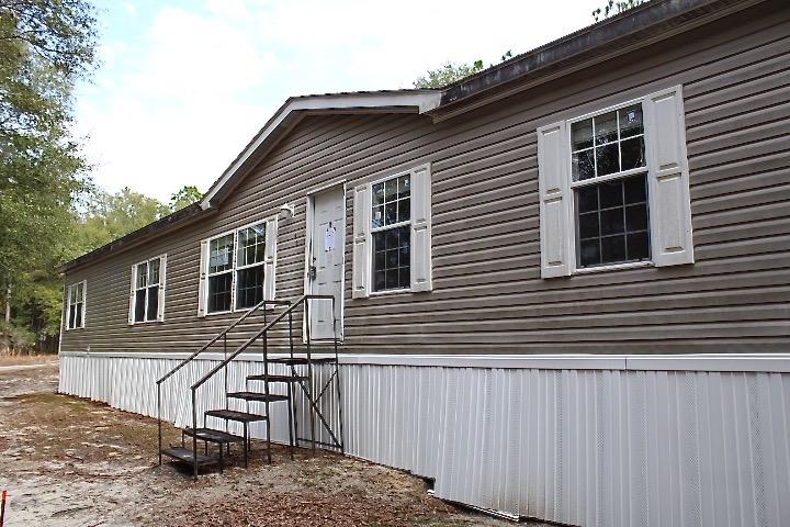 REO. Spacious 4 bedroom 2 bathroom mobile home on 10 acres! Home opens to a HUGE living room with dining room and kitchen close by. Split floor plan allows the bedrooms to be located on opposite ends of the home. The kitchen has tons of cabinets, counter tops and even an island! Home is very conveniently located to schools, shopping, restaurants and parks! Don't let this steal of a deal pass you by! Home is sold ''AS IS''.